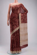 Maroon Tussar Silk Saree with Printed design on the body and Zari Border displayed on a mannequin