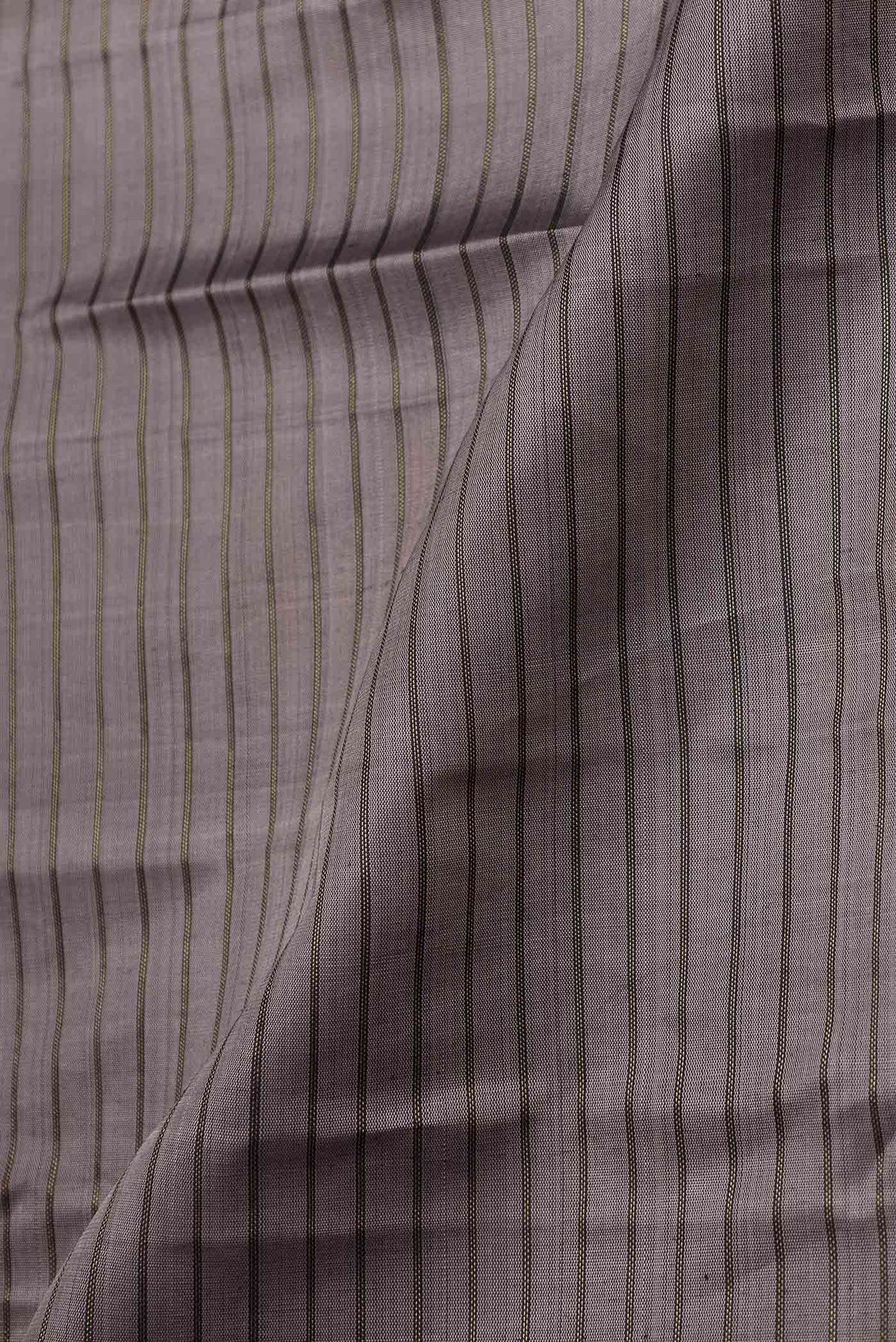 Close up of Grey Dual Tone Kanchipuram Silk Saree with Stripes on the body and Zari Border displaying folds