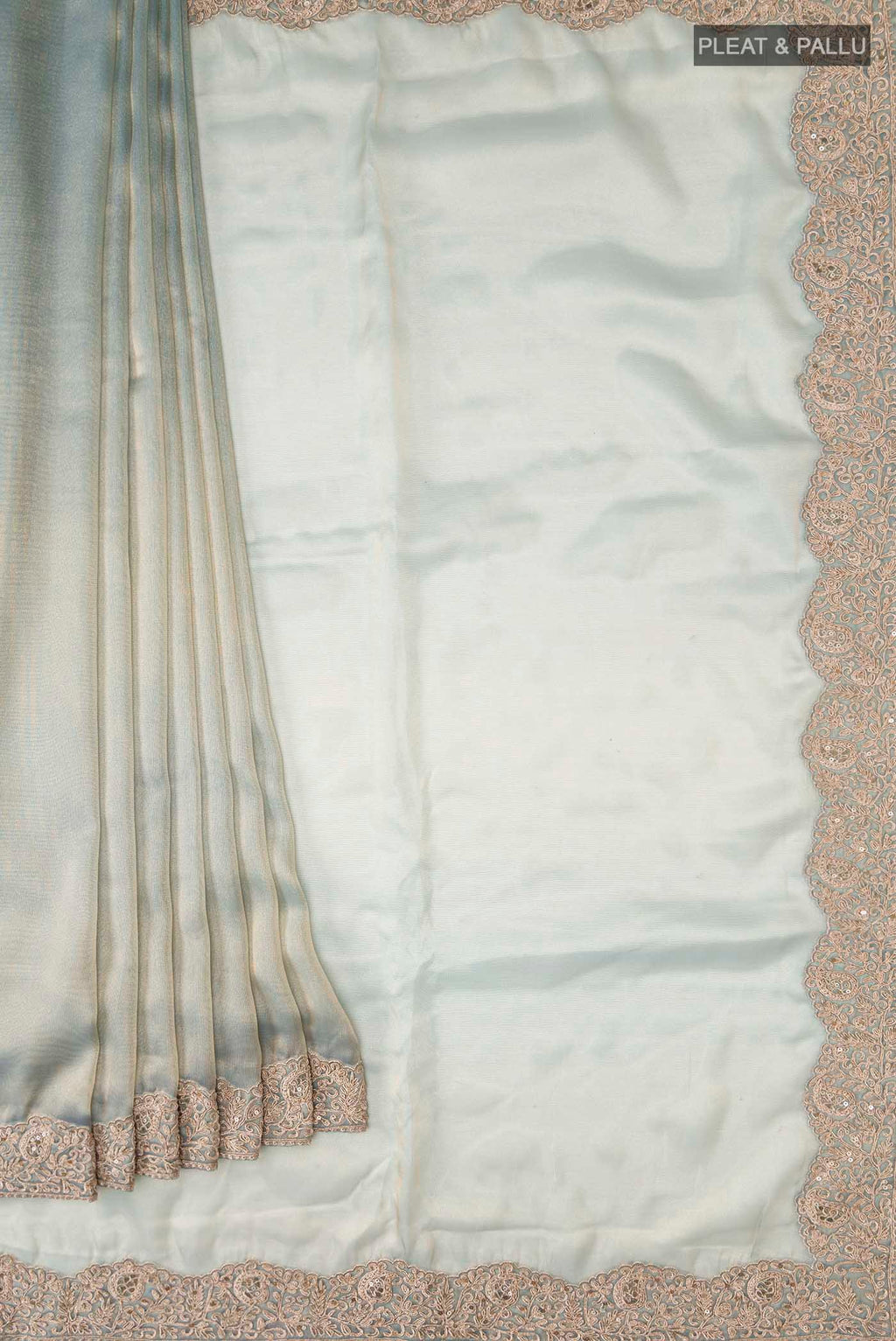 Pleats and pallu of Green Tissue Silk Saree with Plain Body and Embroidery Border