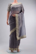 Lilac Tissue Silk Saree with Plain Body and Embroidery Border displayed on a mannequin