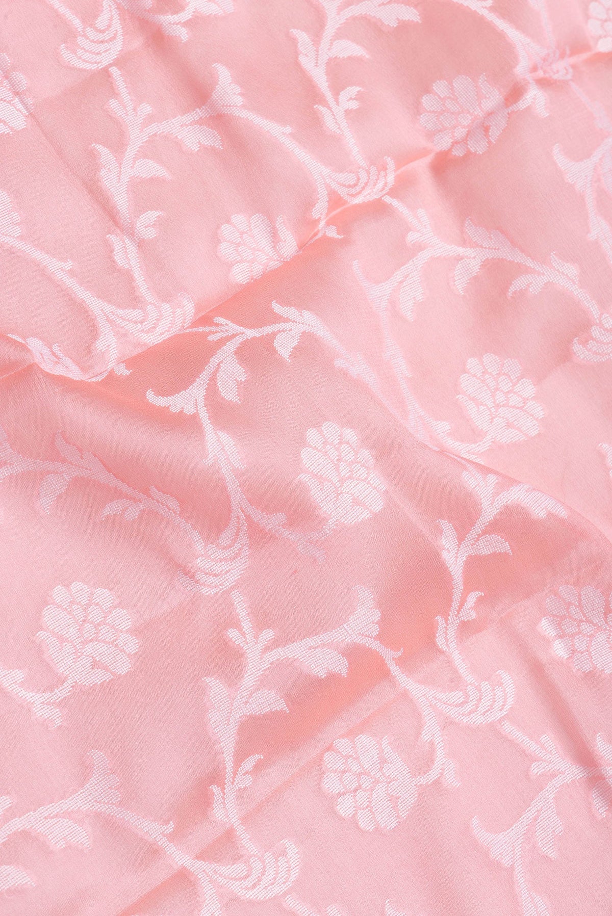 Close up of Pink Dual Tone Mysore Georgette Saree with Zari Brocade on the body and Thread Border.  displaying folds