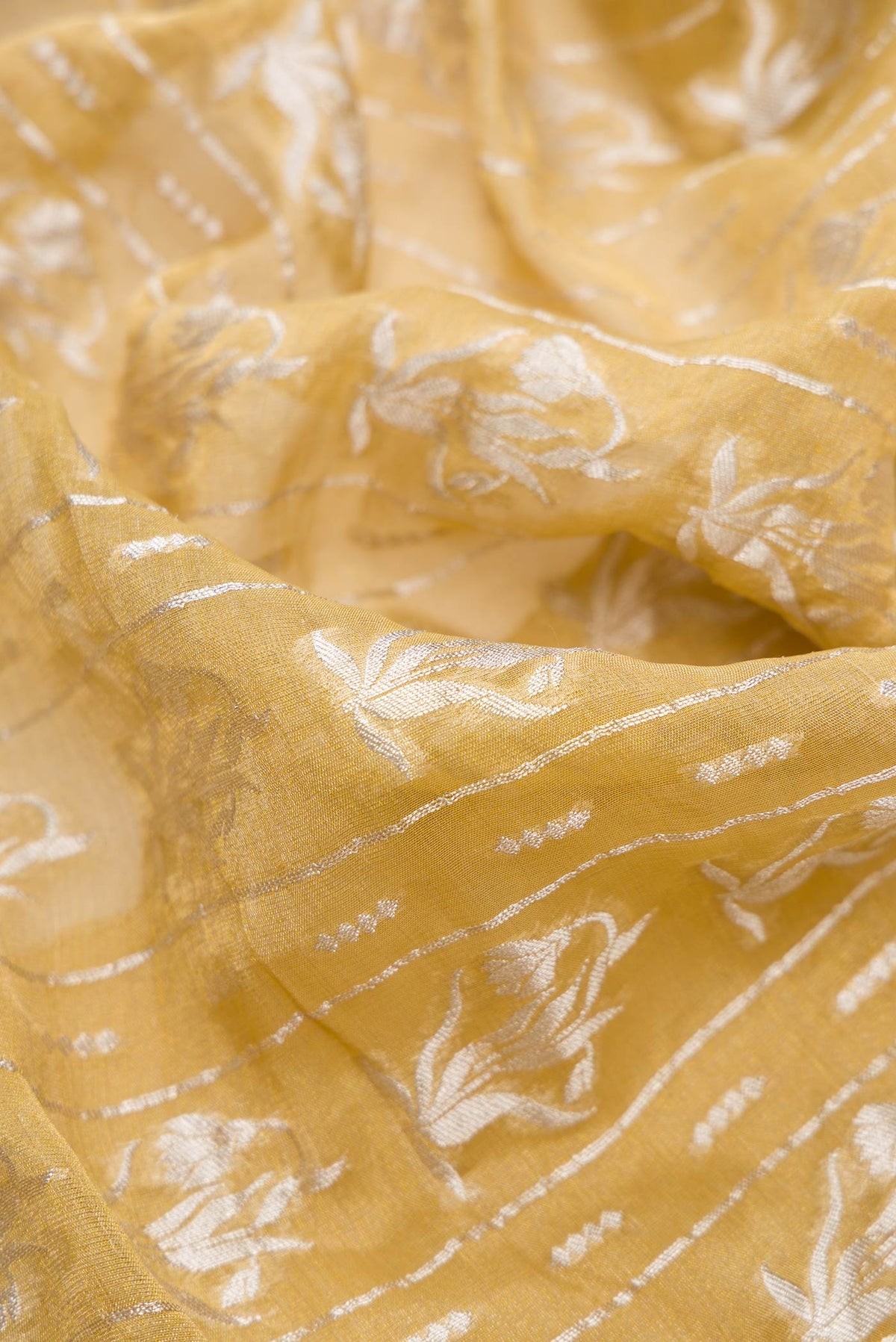 Close up of Mehandi Green Dual Tone Banarasi Georgette Saree with Zari Brocade on the body and Zari Border.  displaying folds