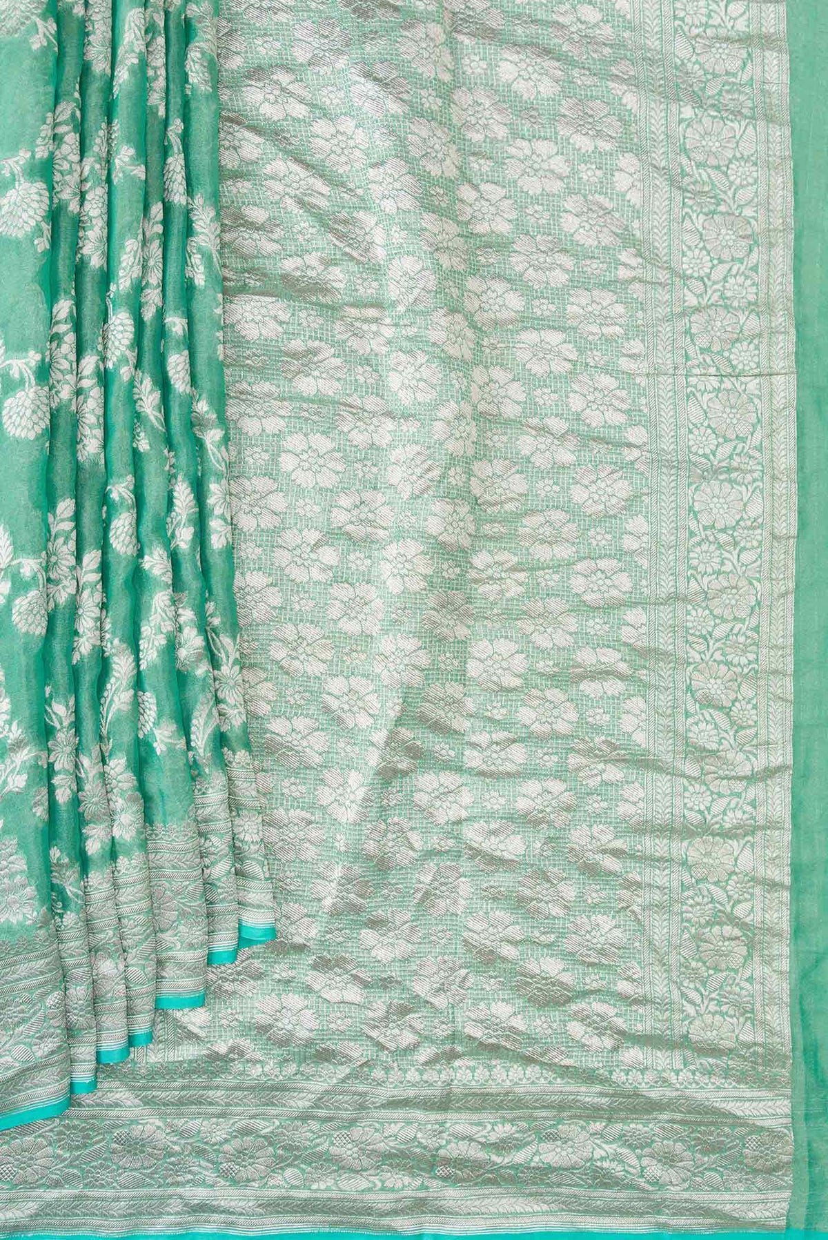 Pleats and pallu of Green Dual Tone Banarasi Georgette Saree with Zari Brocade on the body and Zari Border. 