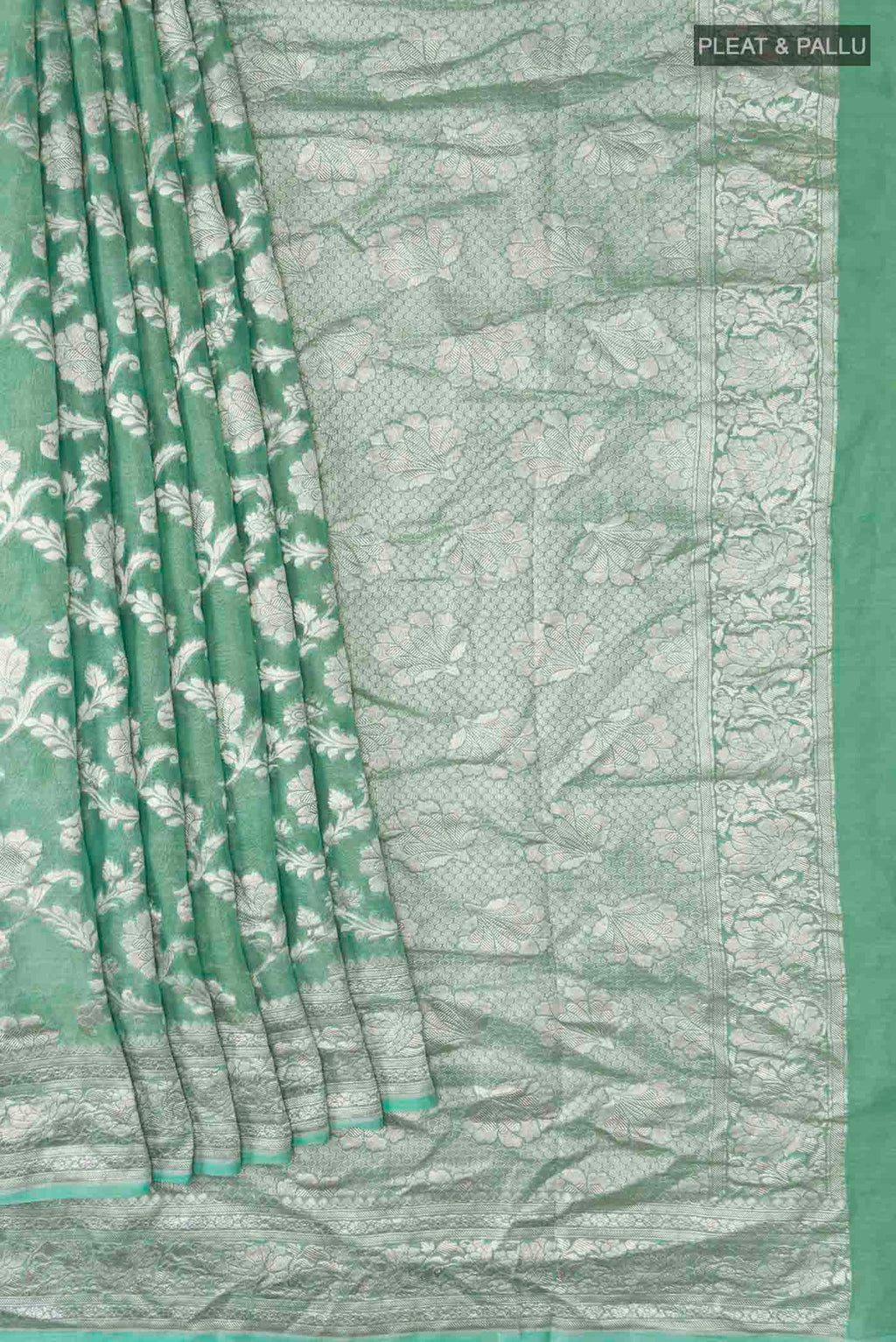 Pleats and pallu of Green Banarasi Georgette Saree with Zari Butta on the body and Zari Border