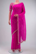 Pink Organza Silk Saree with Embroidery on the body and Embroidery Border displayed on a mannequin
