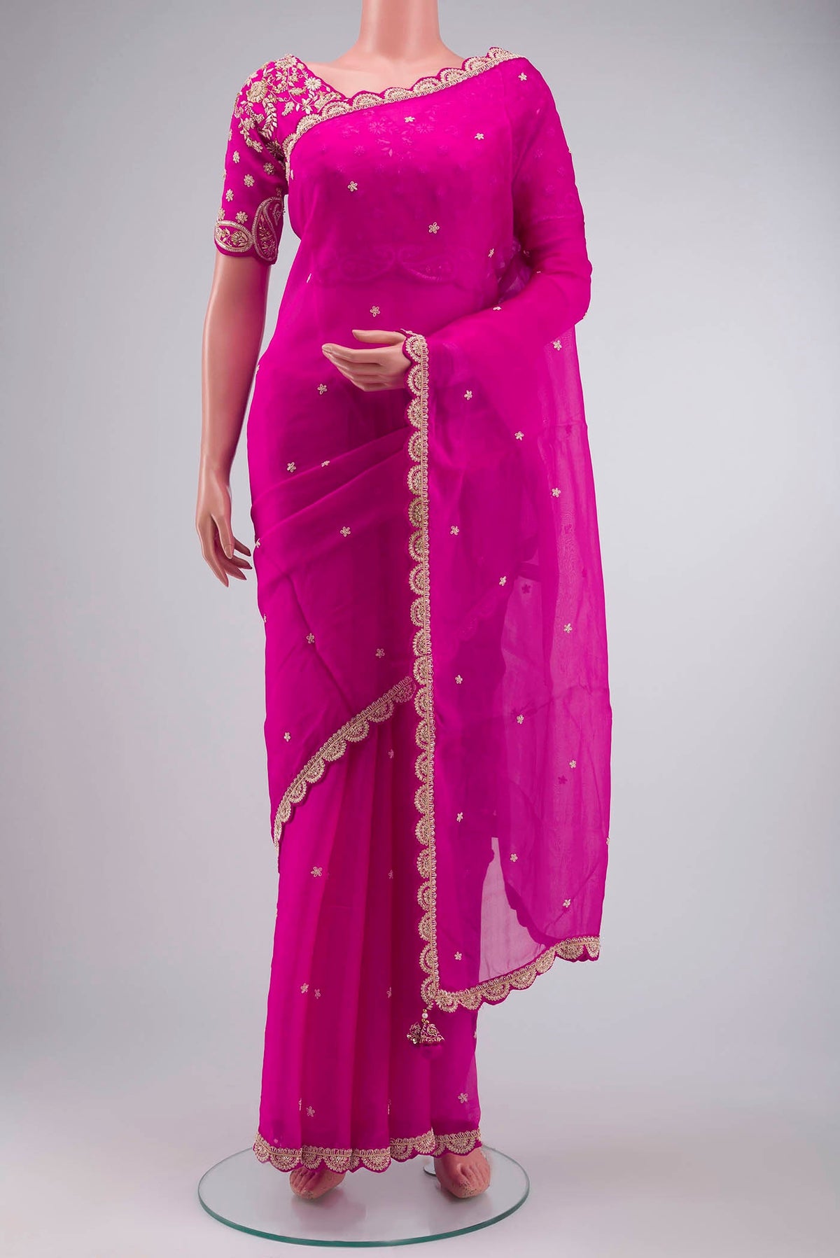 Pink Organza Silk Saree with Embroidery on the body and Embroidery Border displayed on a mannequin