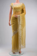 Yellow Organza Silk Saree with Embroidery on the body and Embroidery Border displayed on a mannequin
