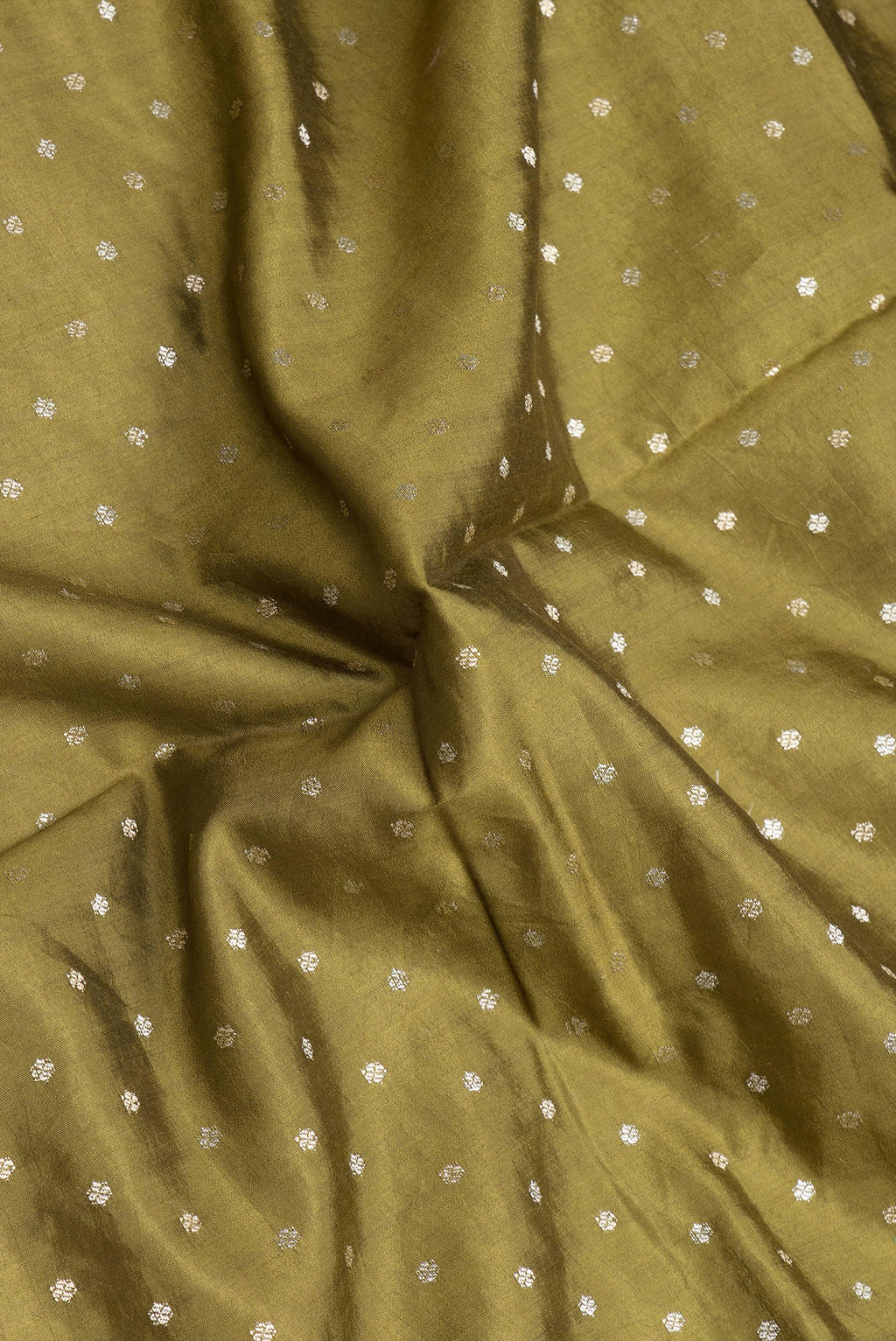 Close up of Mehandi Green Dual Tone Tussar Silk Saree with Zari Butta on the body and Fancy Border.  displaying folds