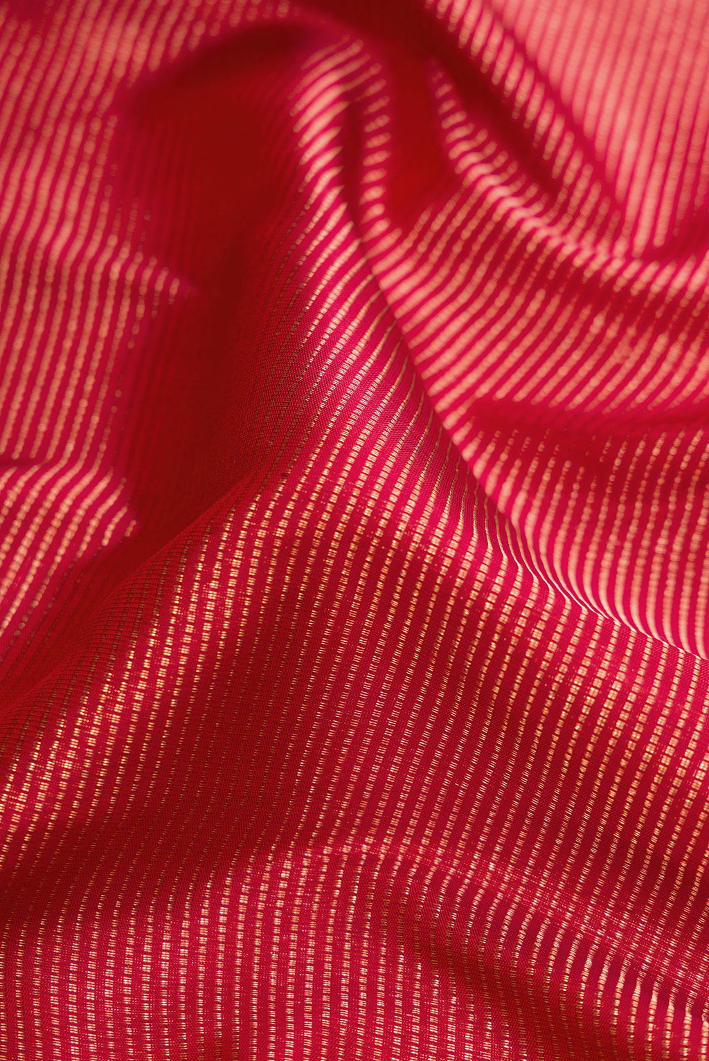 Close up of Red Dual Tone Kanjivaram Silk Saree with Zari Brocade on the body and Zari Border.  displaying folds