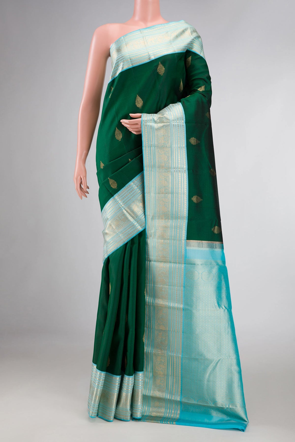 Green Dual Tone Kanchipuram Silk Saree with Zari Butta on the body and Zari Border displayed on a mannequin