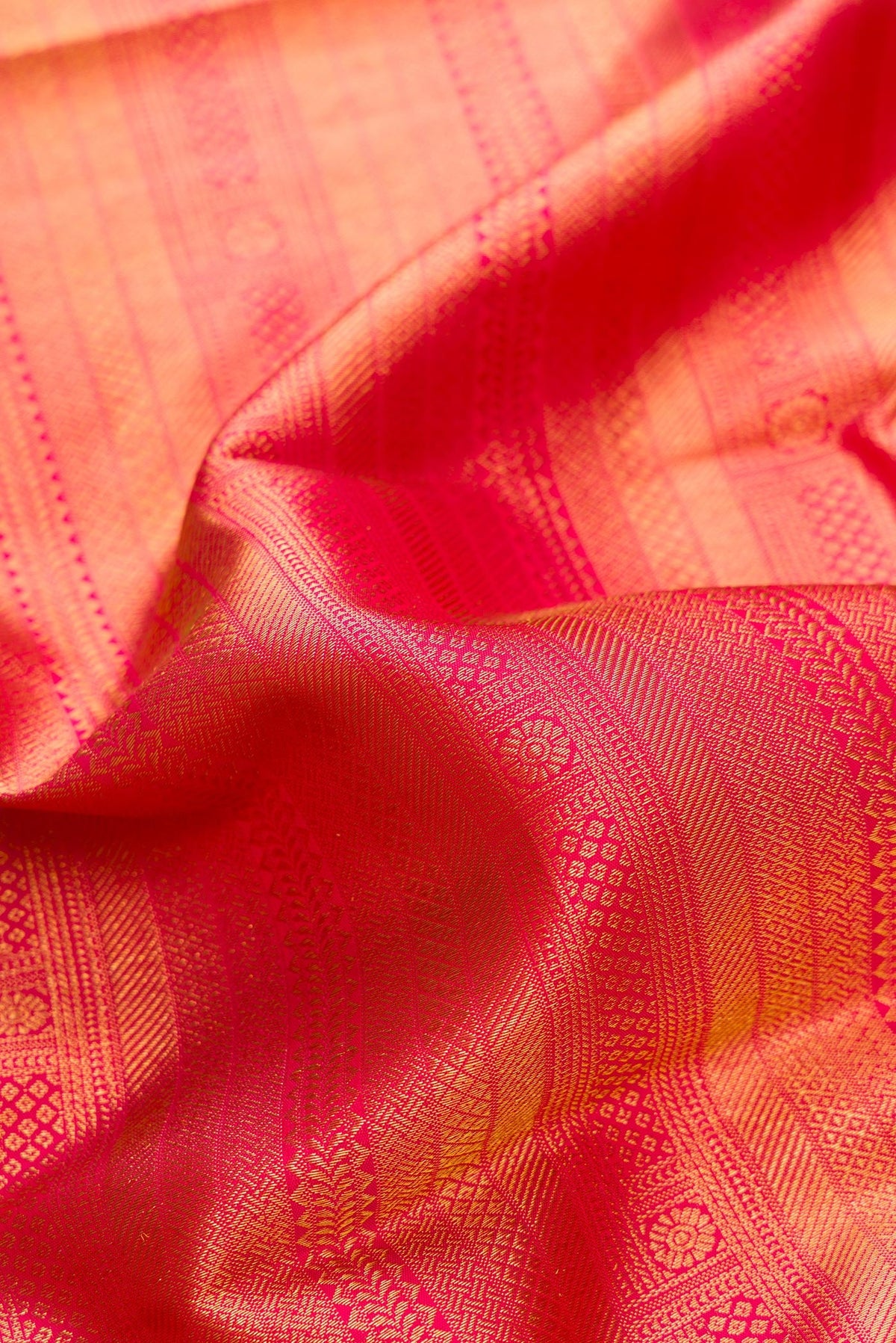 Close up of Pink Dual Tone Kanjivaram Silk Saree with Zari Brocade on the body and Fancy Border.  displaying folds