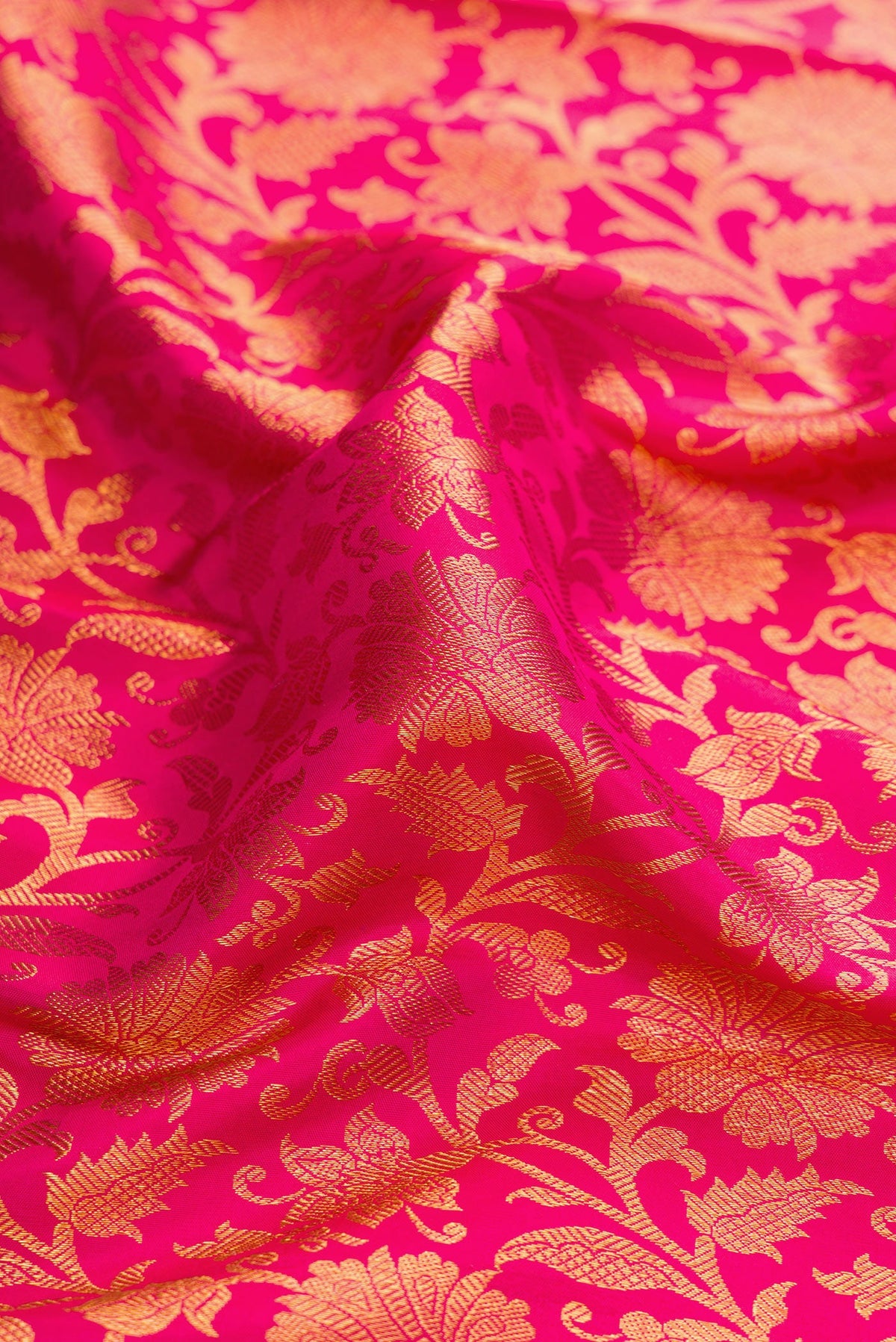 Close up of Dark Pink Dual Tone Kanjivaram Silk Saree with Zari Brocade on the body and Zari Border.  displaying folds