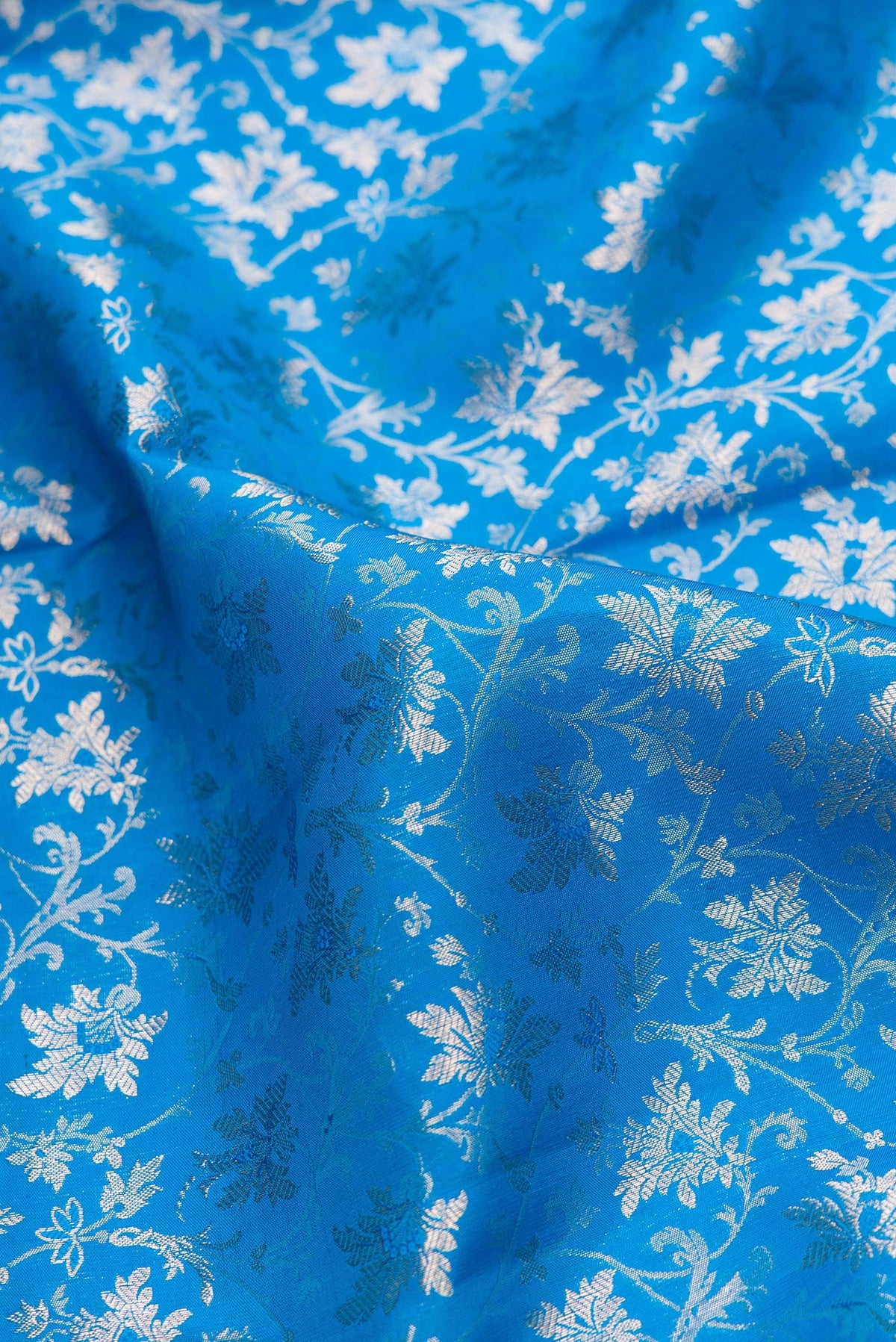 Close up of Sky Blue Dual Tone Kanchipuram Silk Saree with Zari Brocade on the body and Zari Border.  displaying folds