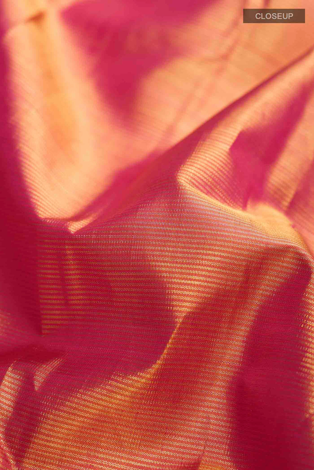 Close up of Orange Kanchipuram Silk Saree with Stripes on the body and Zari Border displaying folds