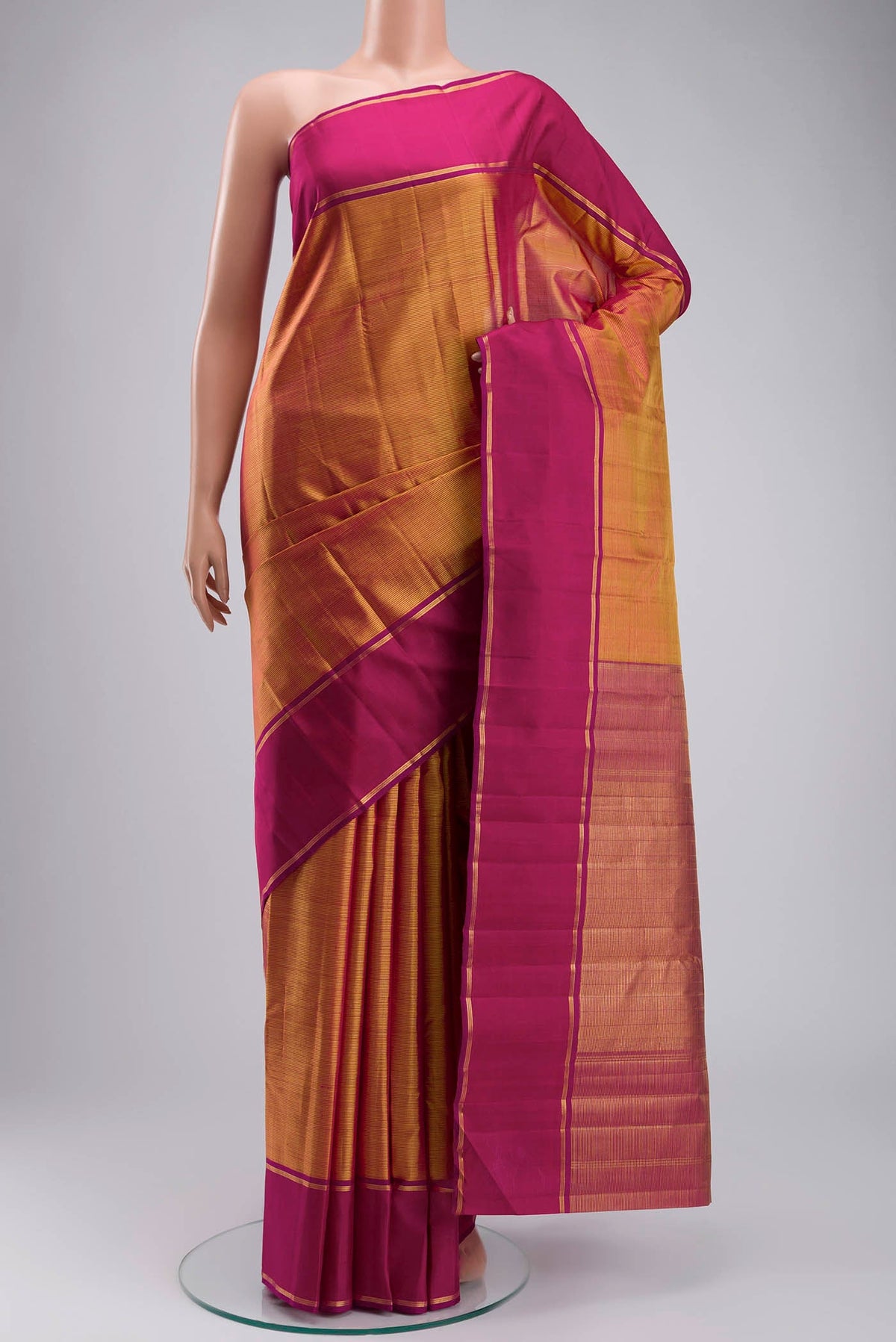 Orange Kanchipuram Silk Saree with Stripes on the body and Zari Border displayed on a mannequin