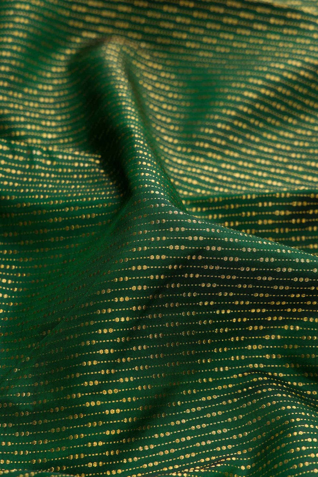Close up of Green Dual Tone Kanchipuram Silk Saree with Stripes on the body and Fancy Border displaying folds