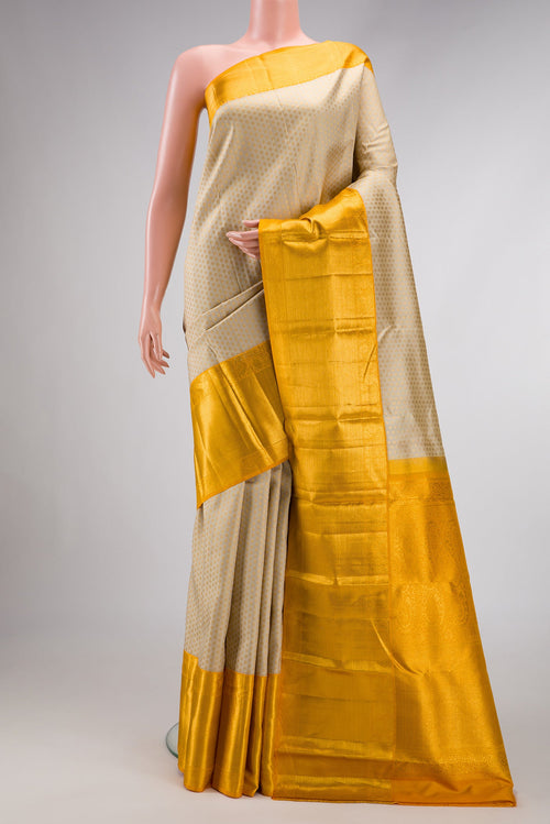 Beige Dual Tone Kanjivaram Silk Saree with Zari Brocade on the body and Zari Border.  displayed on a mannequin
