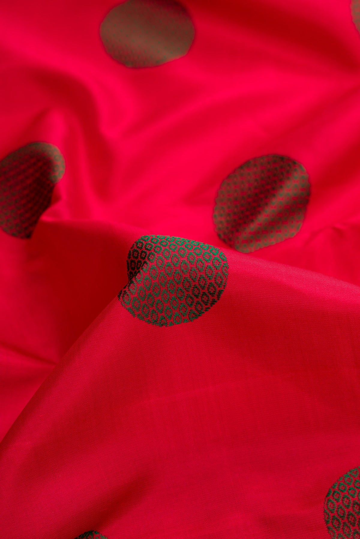 Close up of Pure Silk Pure Zari Red Dual Tone Kanchipuram Saree with Thread Butta on the body and Zari And Thread Border.  displaying folds