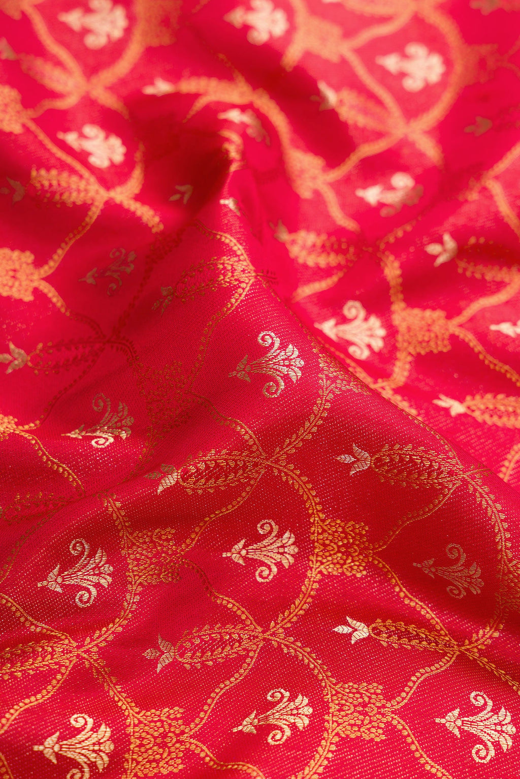 Close up of Red Dual Tone Kanjivaram Silk Saree with Zari Brocade on the body and Fancy Border.  displaying folds