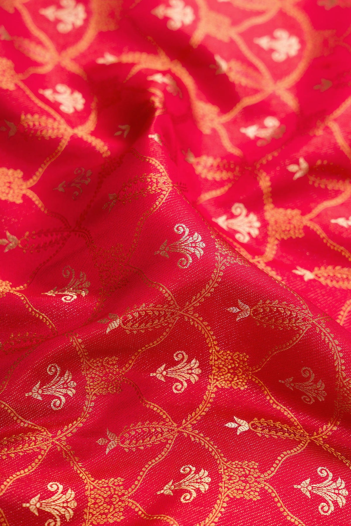 Close up of Red Dual Tone Kanjivaram Silk Saree with Zari Brocade on the body and Fancy Border.  displaying folds