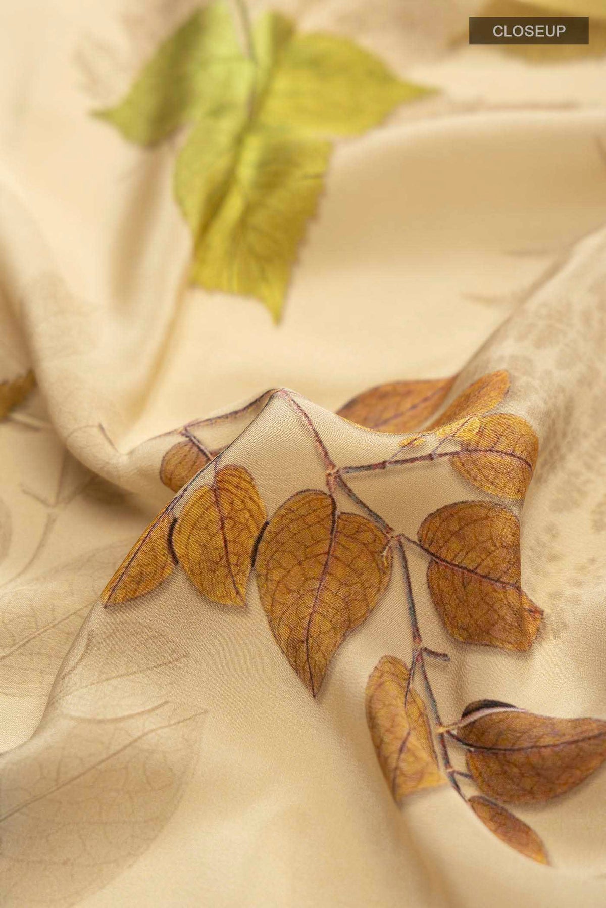 Close up of Beige Mysore Crepe Saree with Printed design on the body and Plain Border displaying folds
