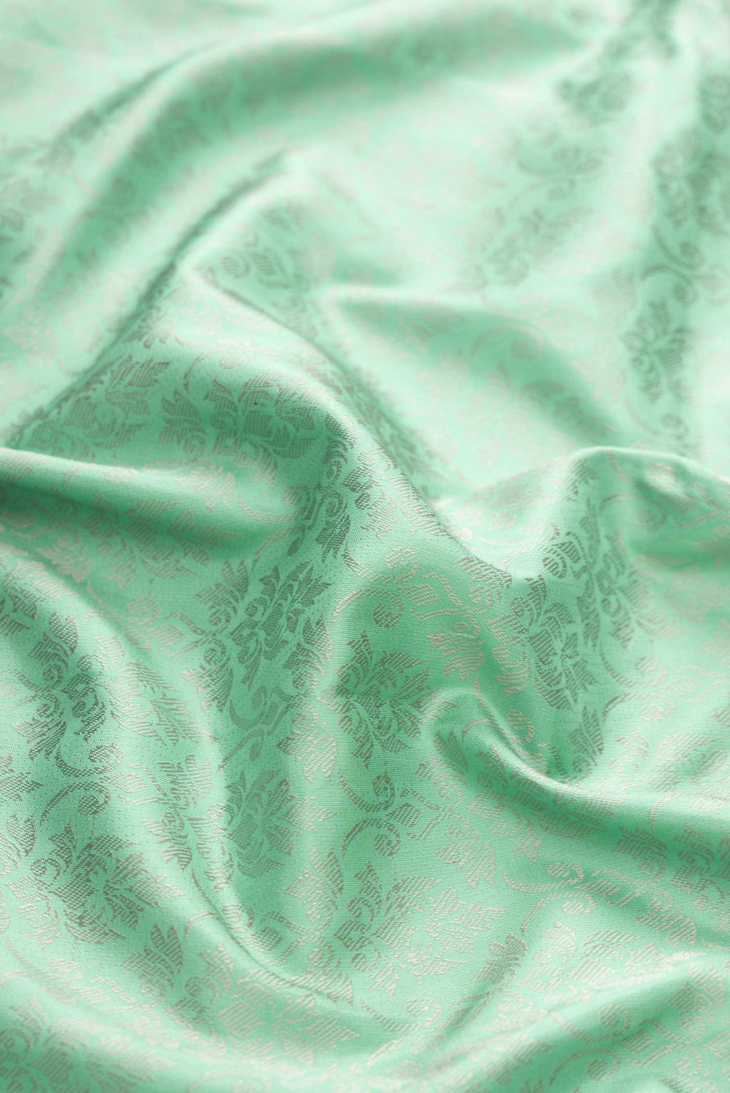 Close up of Sea Green Dual Tone Kanchipuram Silk Saree with Jacquard design on the body and Fancy Border displaying folds