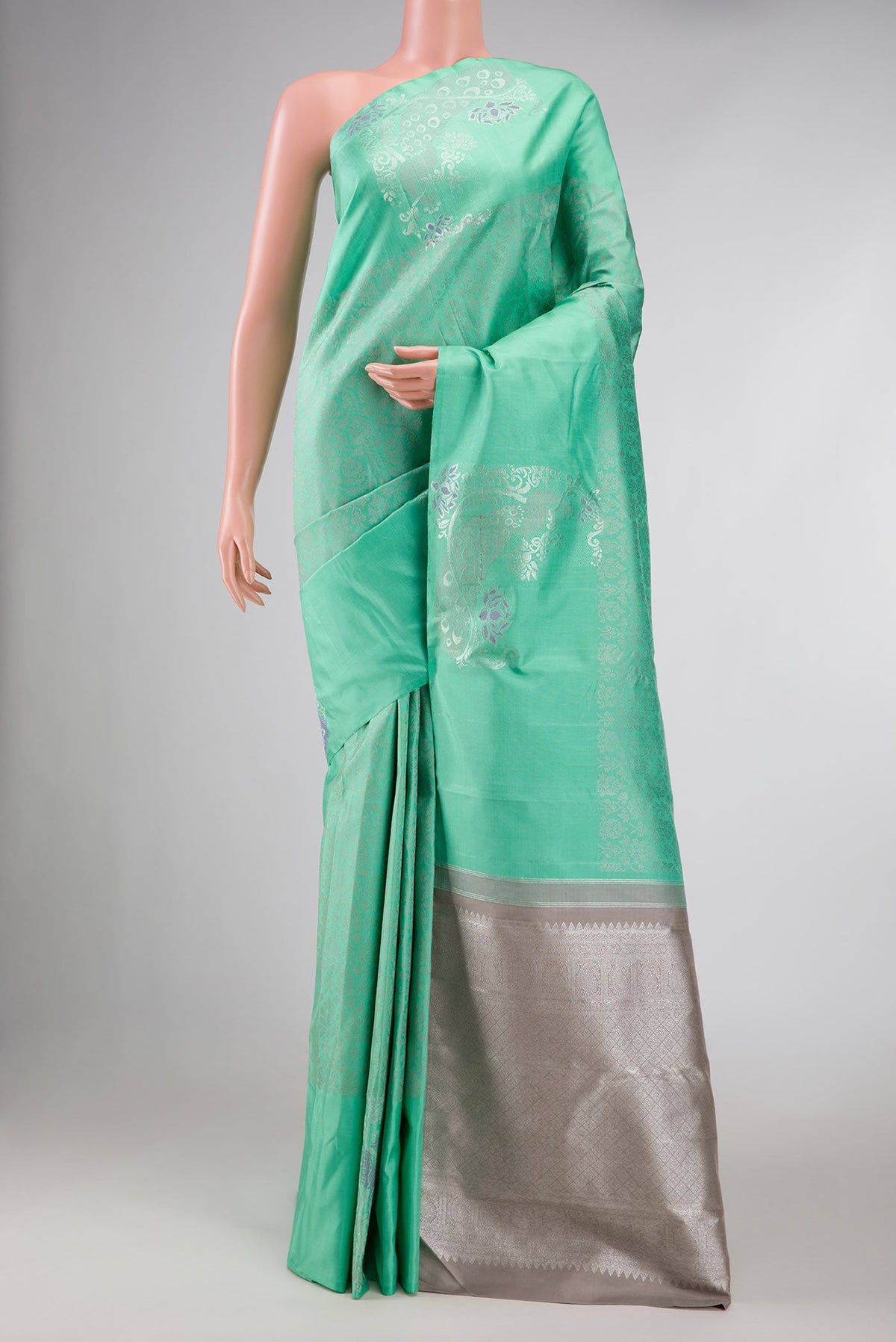 Sea Green Dual Tone Kanchipuram Silk Saree with Jacquard design on the body and Fancy Border displayed on a mannequin