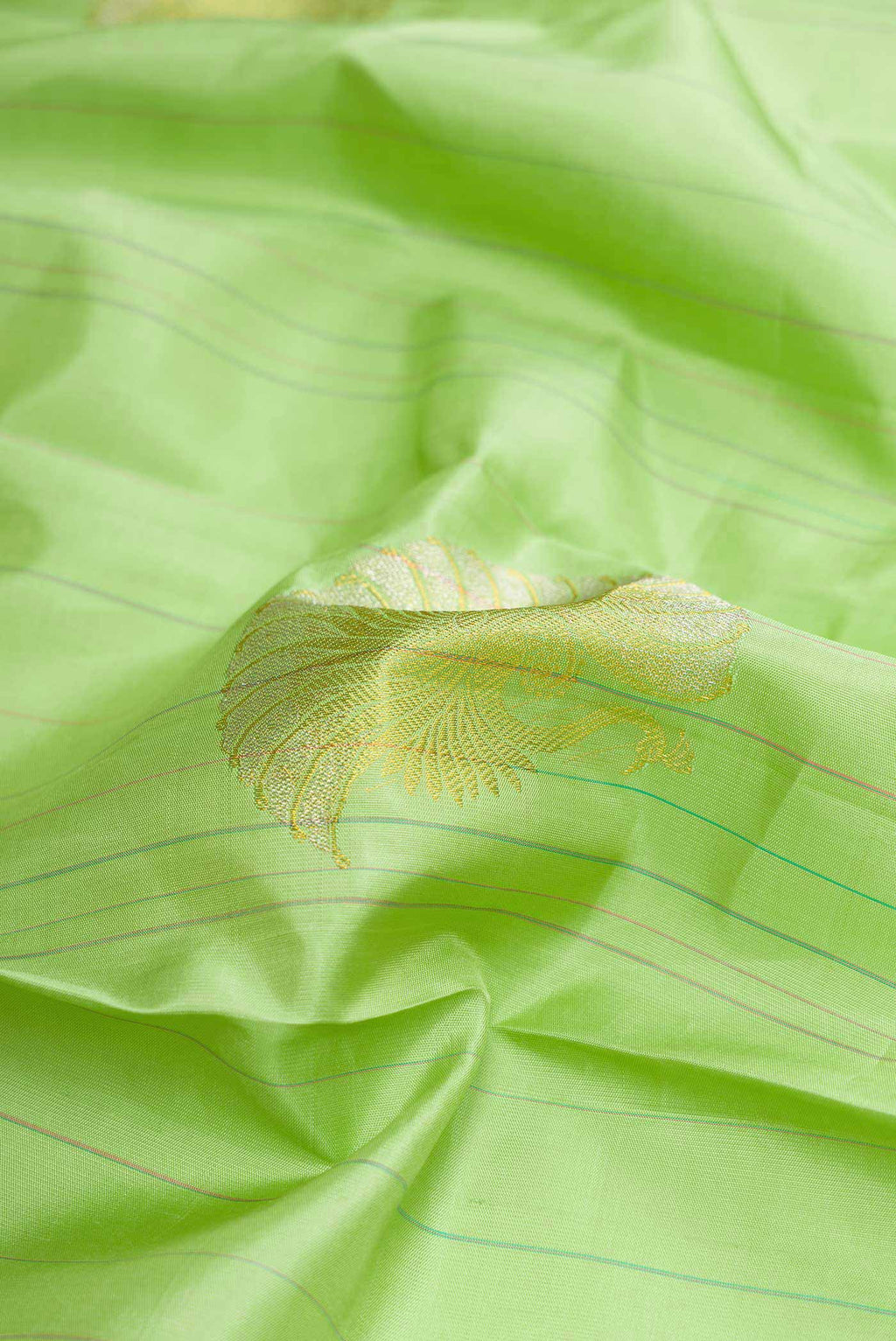 Close up of Pista Green Dual Tone Kanchipuram Silk Saree with Stripes on the body and Without Border displaying folds