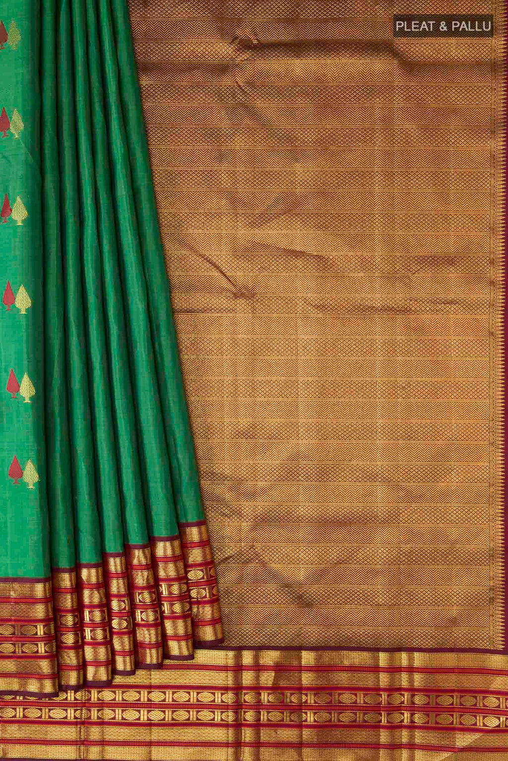 Pleats and pallu of Green Kanchipuram Silk Saree with Zari Butta on the body and Zari Border
