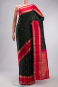 Green Kanchipuram Silk Saree with Zari Butta on the body and Zari Border displayed on a mannequin