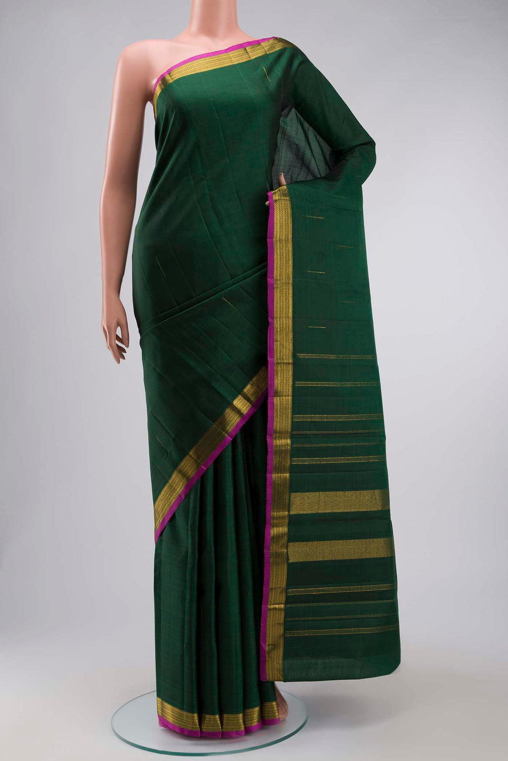 Green Kanchipuram Silk Saree with Zari Butta on the body and Zari Border displayed on a mannequin