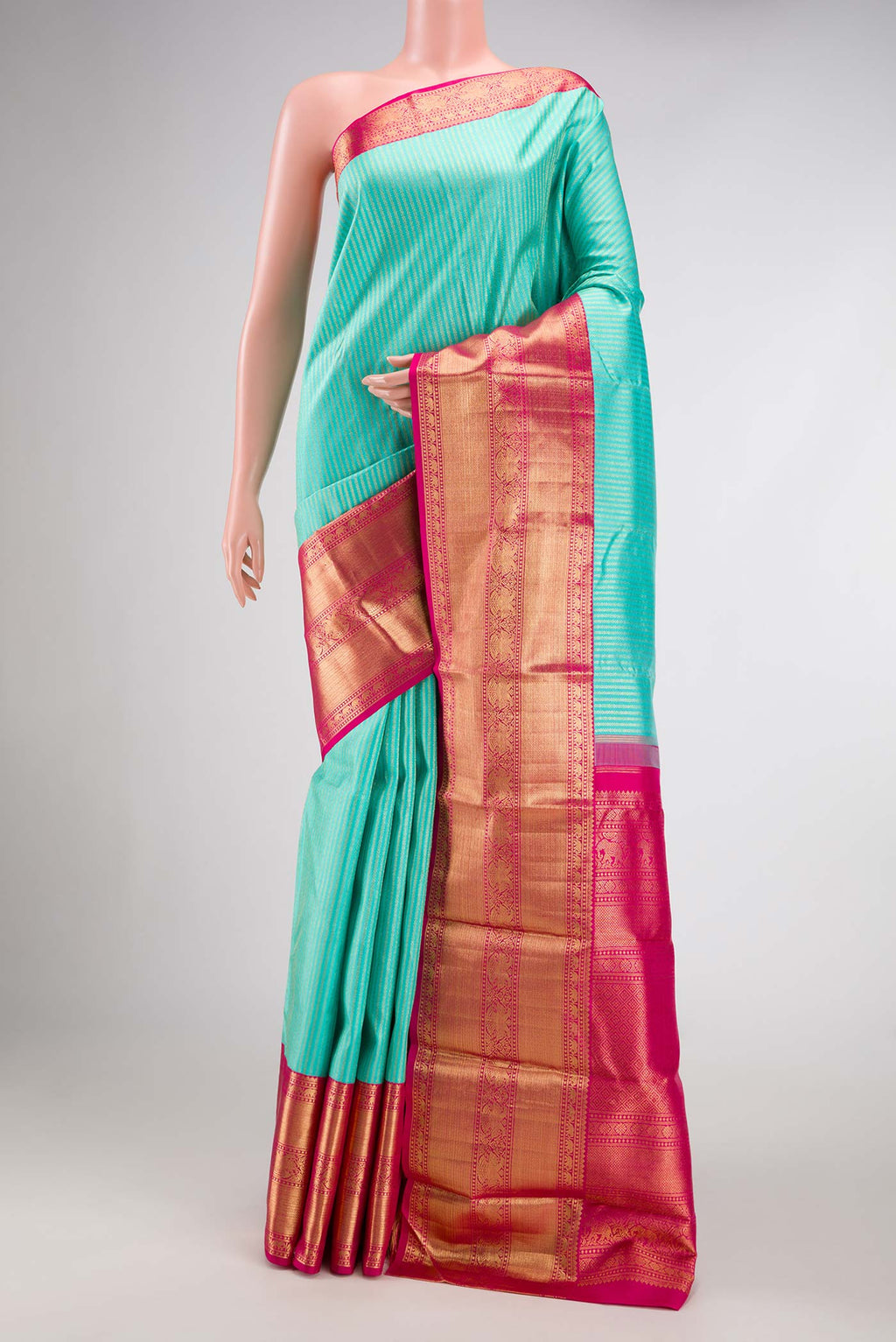 Sea Green Dual Tone Kanchipuram Silk Saree with Zari Brocade on the body and Zari Border.  displayed on a mannequin
