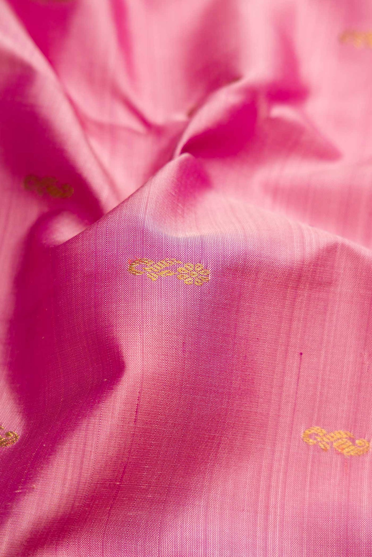 Close up of Pink Dual Tone Kanjivaram Silk Saree with Zari Butta on the body and Zari Border.  displaying folds