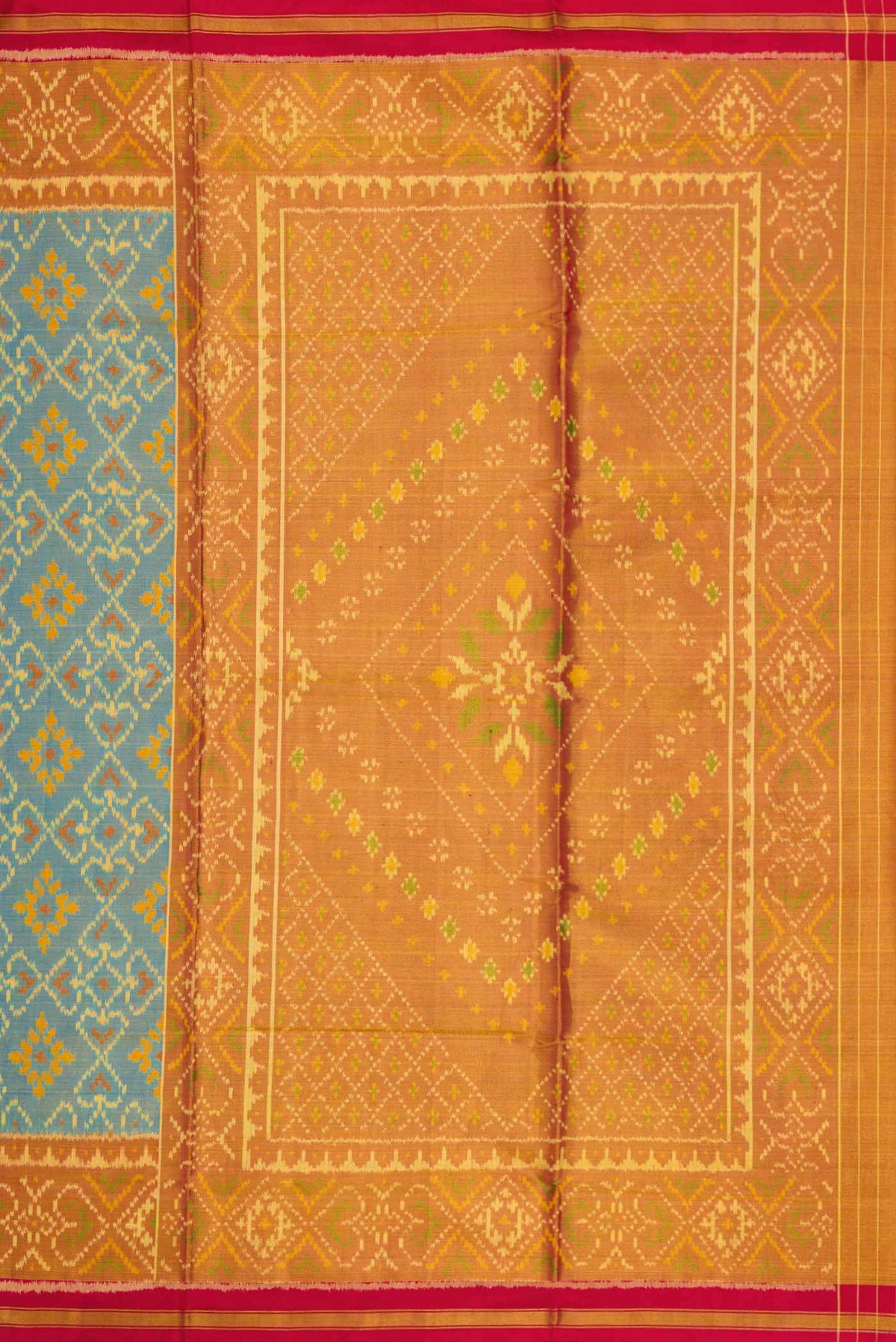Close up image of the pallu of Light Blue Dual Tone Rajkot Patola Silk Saree with Ikat Print on the body and Zari Border