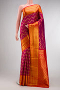 Magenta Kanchipuram Silk Saree with Zari Brocade on the body and Zari Border.  displayed on a mannequin
