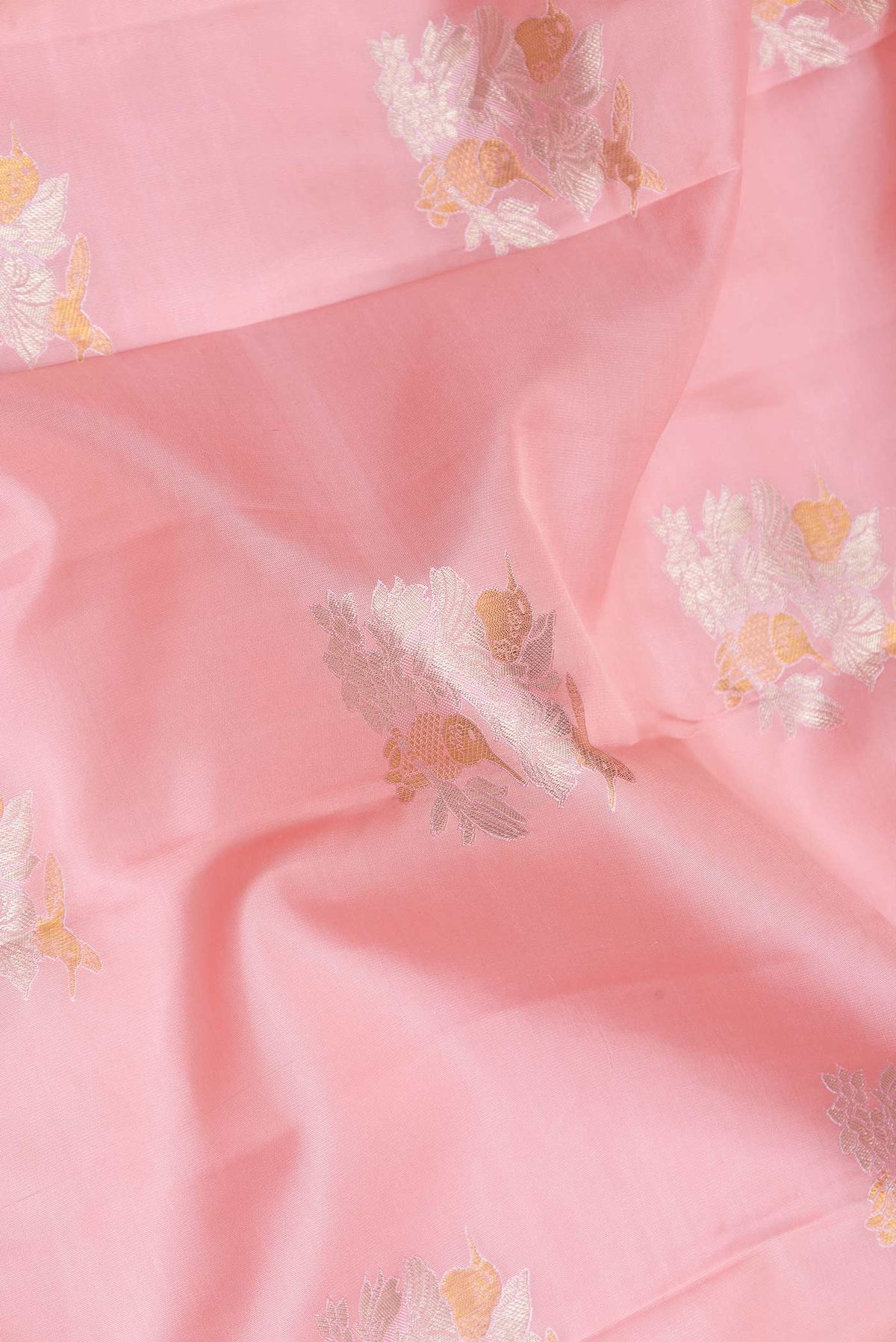 Close up of Pink Dual Tone Kanchipuram Saree with Zari Butta on the body and Zari Border displaying folds
