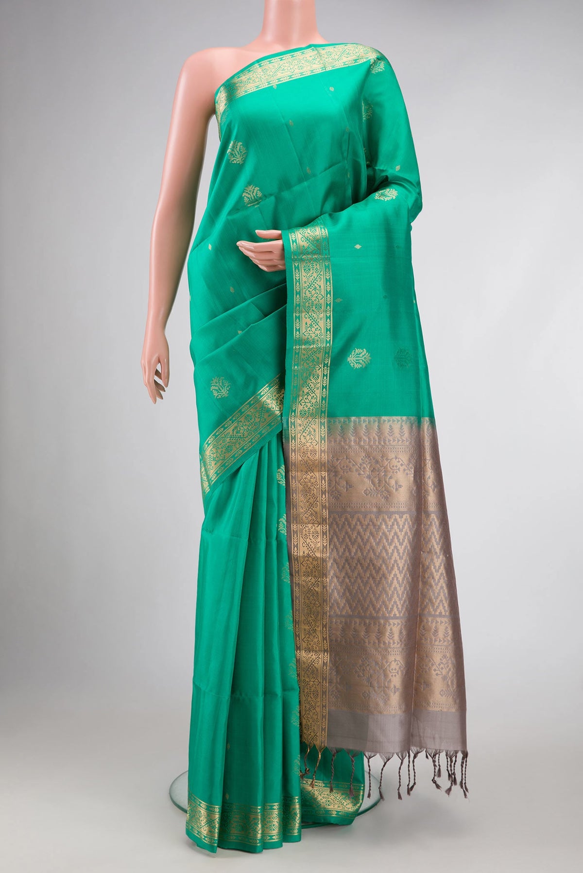 Sea Green Dual Tone Soft Silk Saree with Zari Butta on the body and Zari Border.  displayed on a mannequin