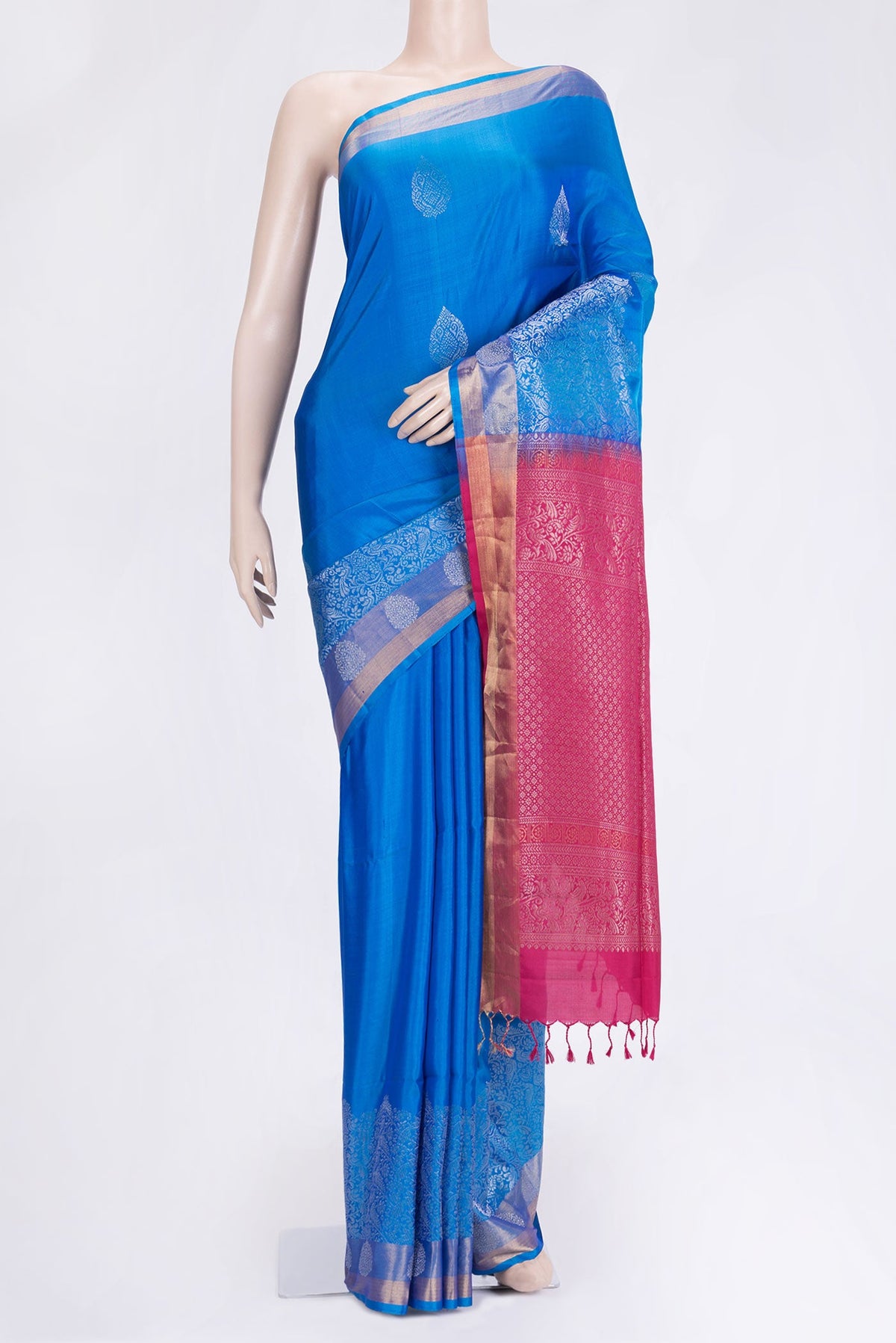 Peacock Blue Dual Tone Soft Silk Saree with Zari Butta on the body and Zari Border.  displayed on a mannequin