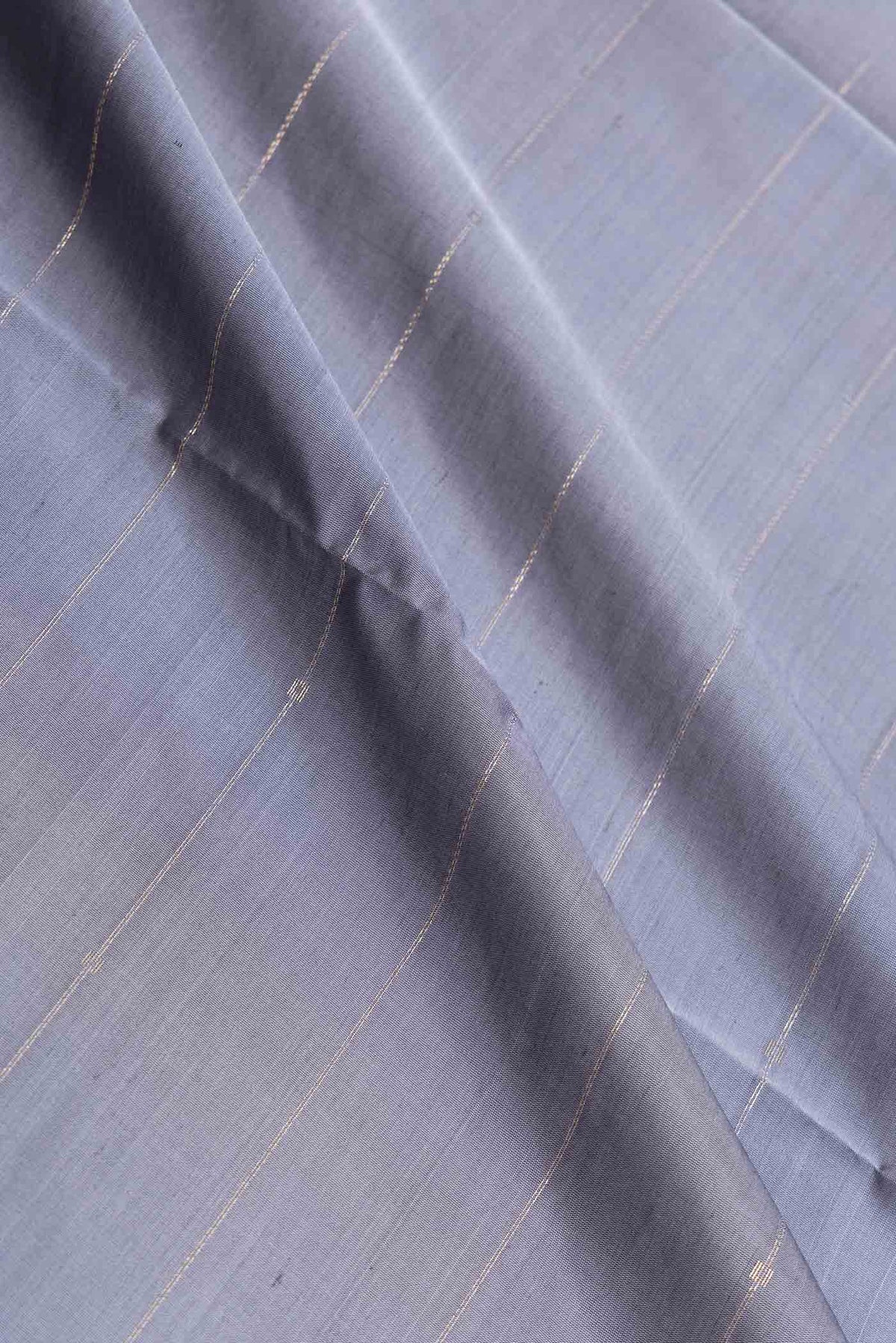 Close up of Grey Dual Tone Soft Silk Saree with Stripes on the body and Zari Border displaying folds