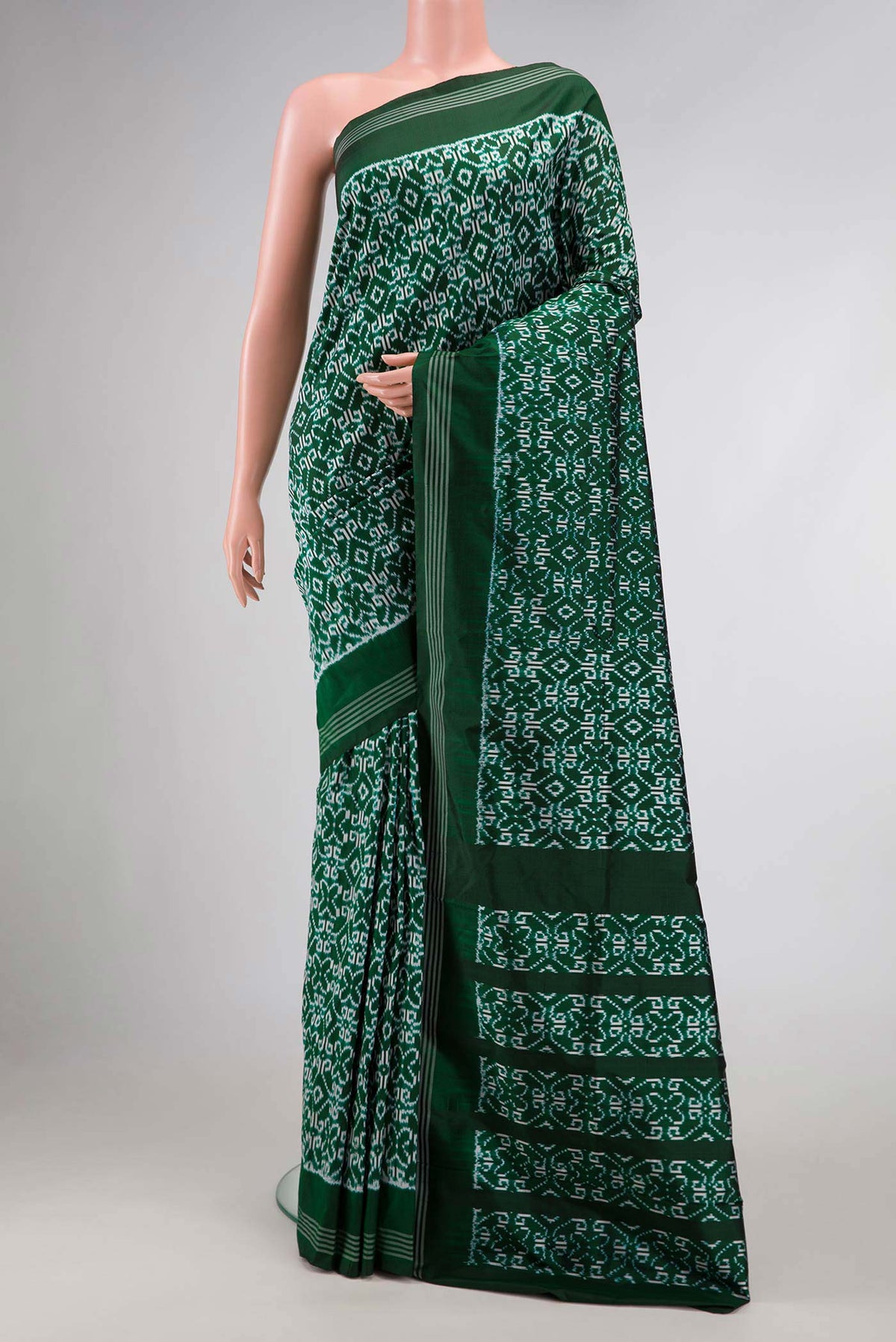Green Dual Tone Double Ikat Saree with Ikat Print on the body and Zari Border.  displayed on a mannequin