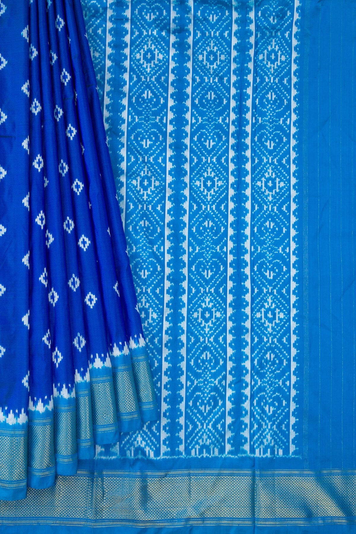 Pleats and pallu of Peacock Blue Dual Tone Double Ikat Nine Yards Saree with Ikat Print on the body and Zari Border. 