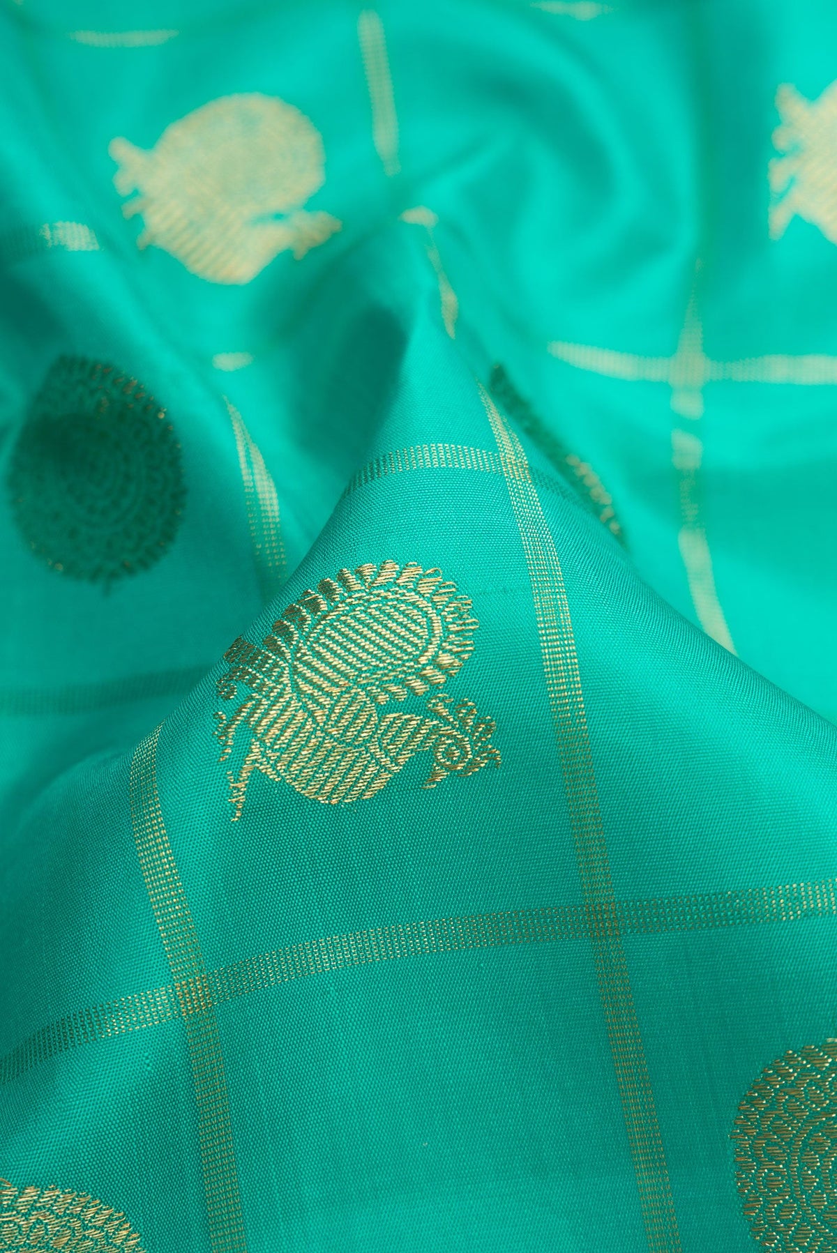 Close up of Pure Silk Pure Zari Sea Green Dual Tone Kanjivaram Saree with Checked design on the body and Zari Border.  displaying folds