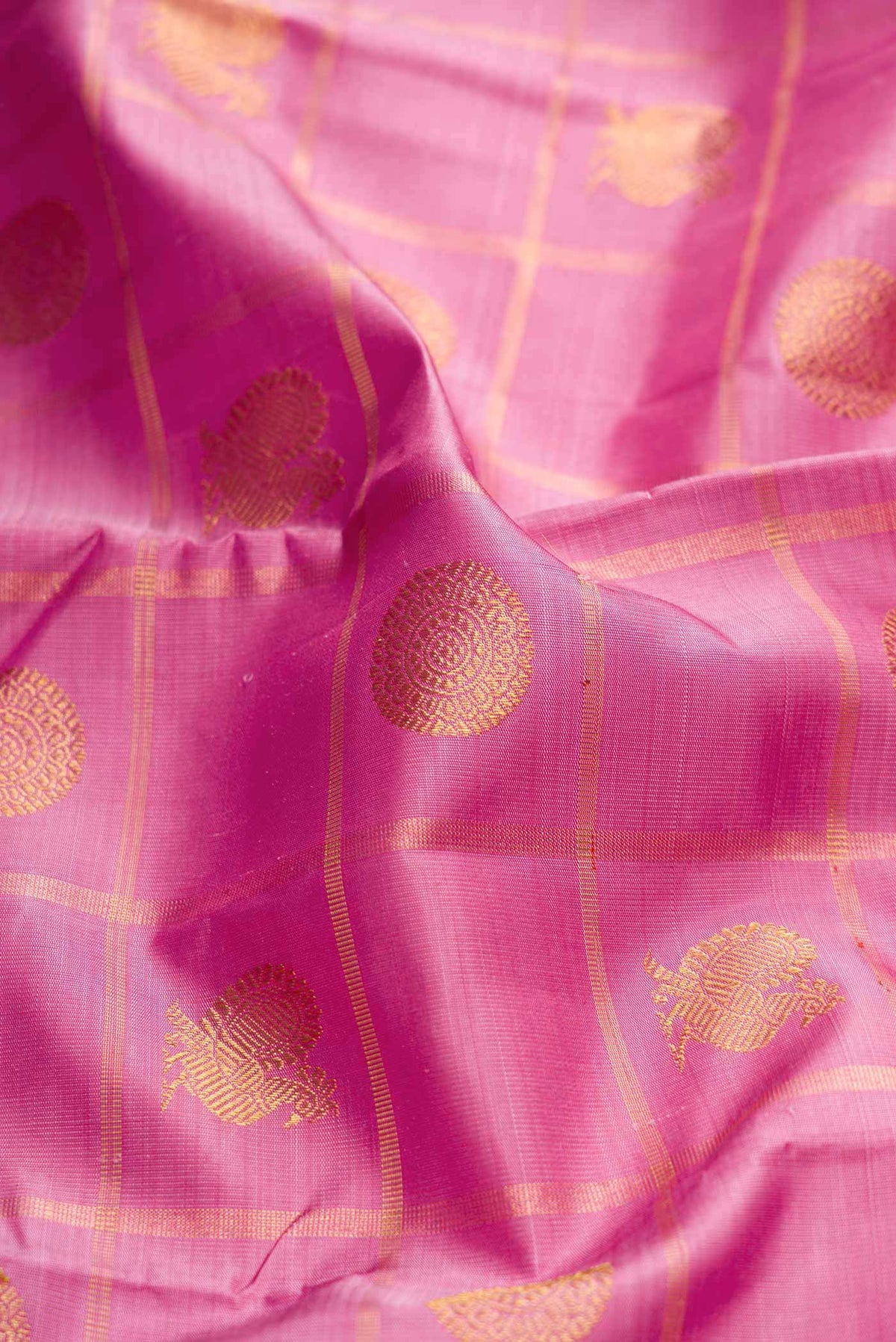 Close up of Pure Silk Pure Zari Rose pink Dual Tone Kanchipuram Saree with Checked design on the body and Zari Border displaying folds