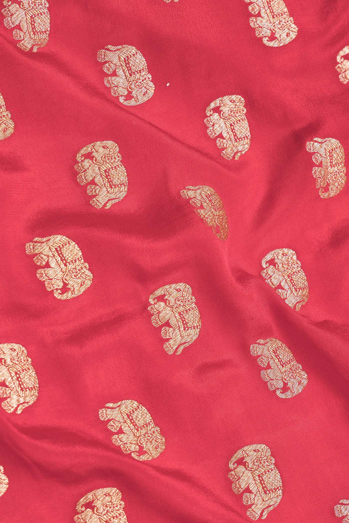 Close up of Red Dual Tone Banarasi Georgette Saree with Zari Butta on the body and Zari Border.  displaying folds