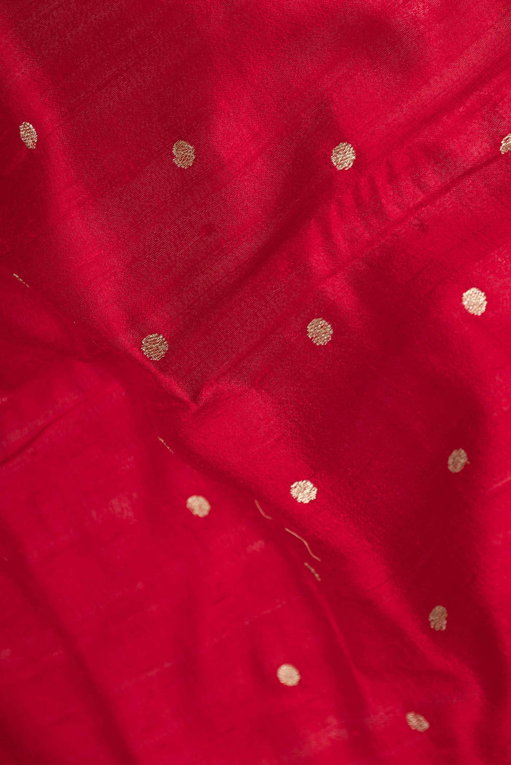 Close up of Red Tussar Silk Saree with Embroidery on the body and Embroidery Border displaying folds