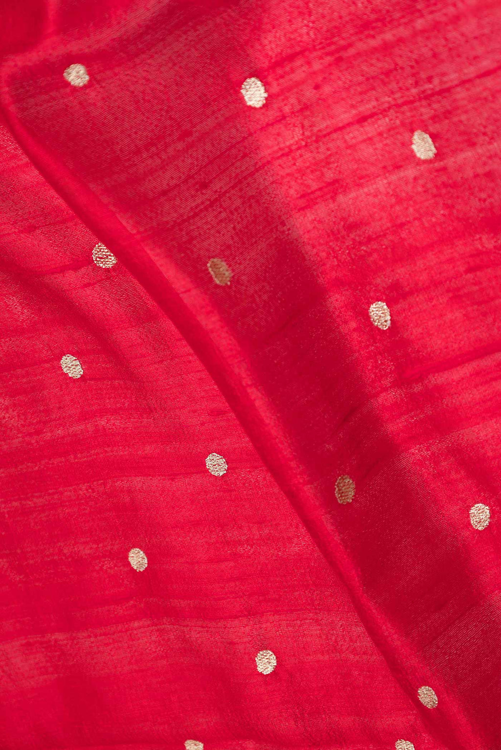 Close up of Red Dual Tone Tussar Saree with Zari Butta on the body and Embroidery Border displaying folds