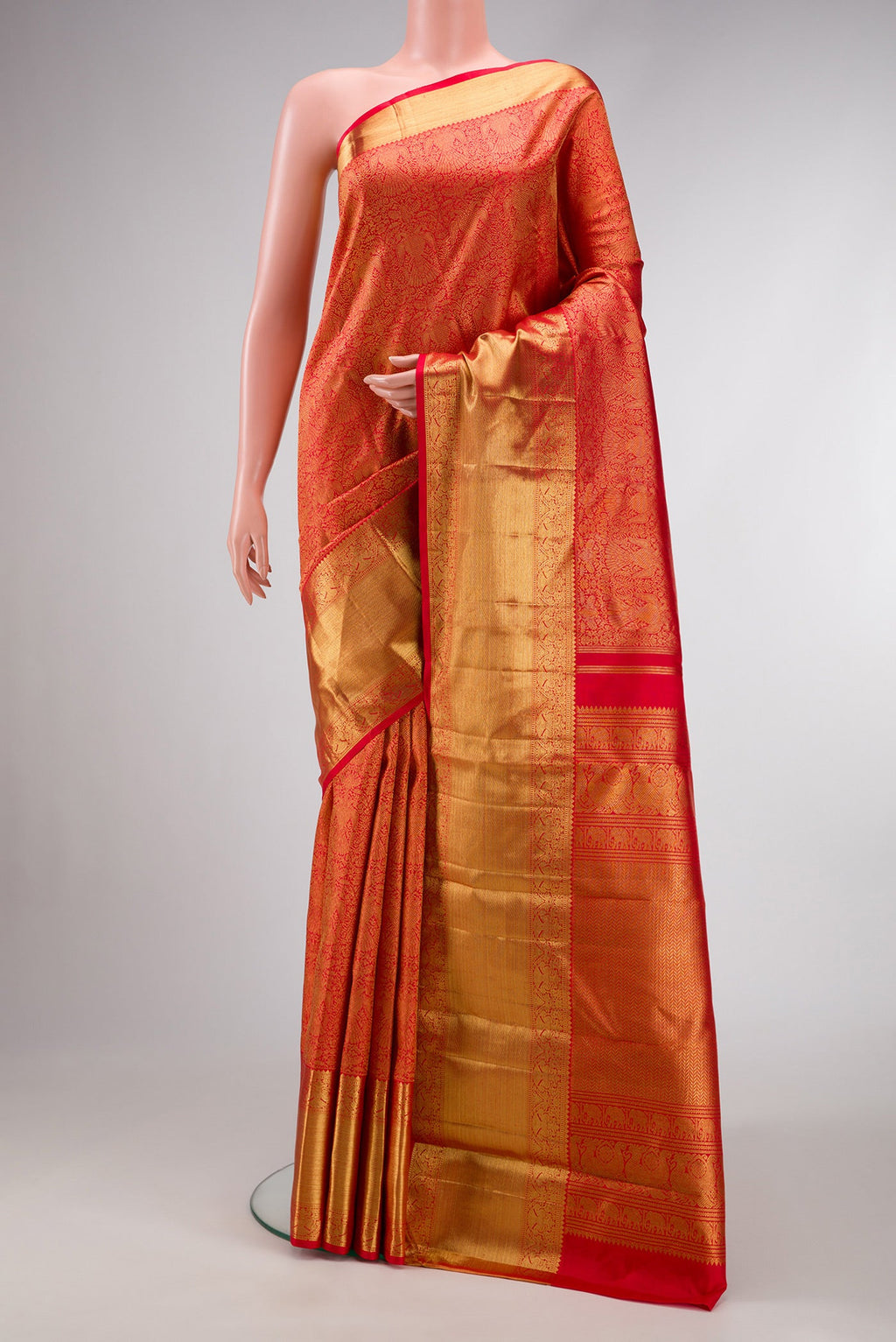 Pure Silk Pure Zari Red Dual Tone Kanjivaram Saree with Zari Brocade on the body and Zari Border.  displayed on a mannequin