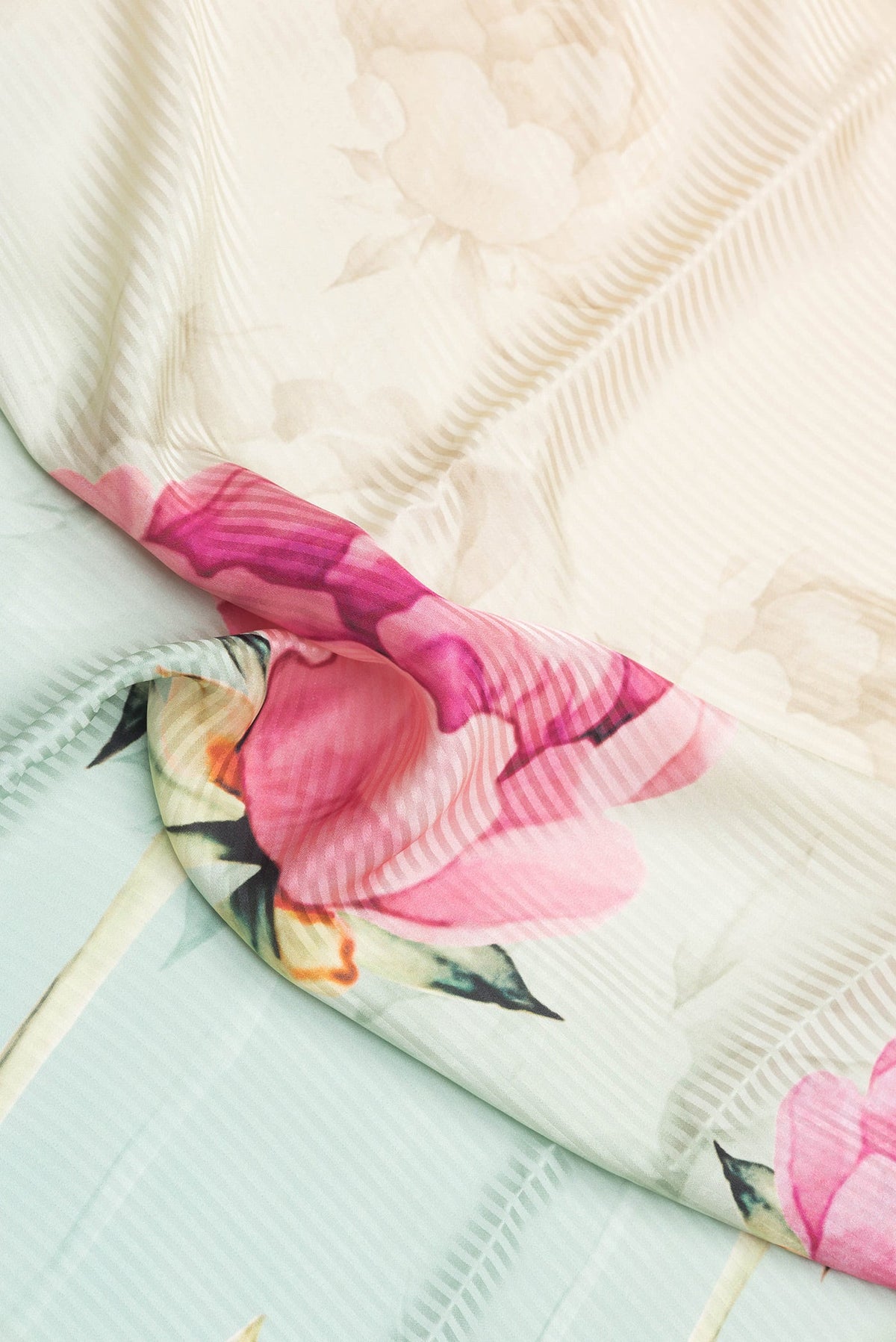 Close up of Sea Green Dual Tone Crepe Saree with Printed design on the body and Without Border.  displaying folds