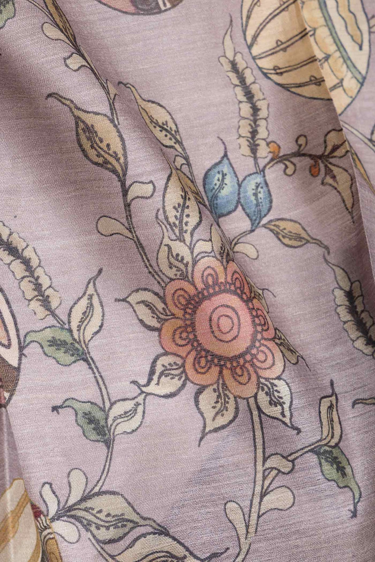 Close up of Purple Dual Tone Tussar Saree with kalamkari Print on the body and Fancy Border.  displaying folds