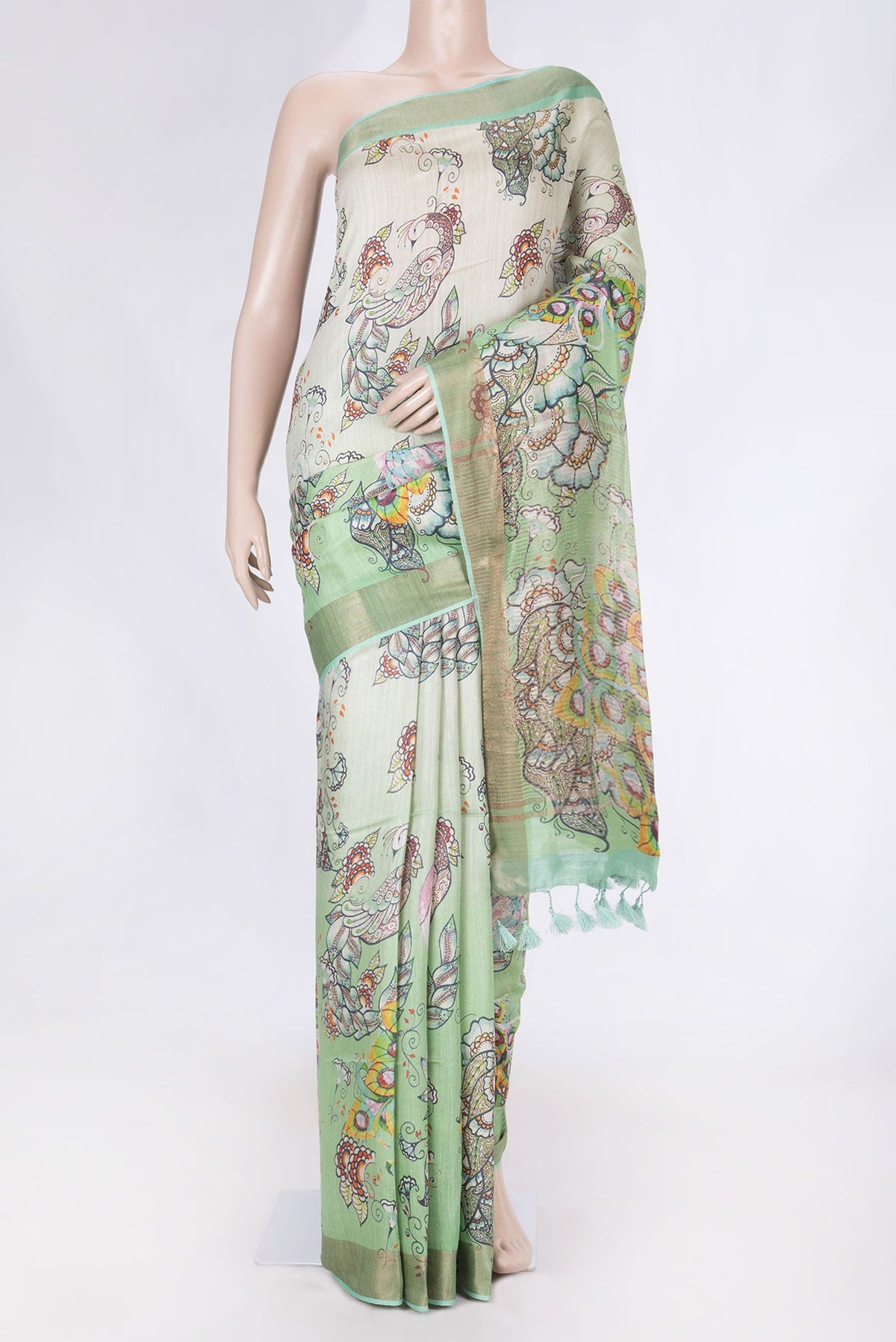 Green Dual Tone Tussar Saree with Printed design on the body and Zari Border displayed on a mannequin